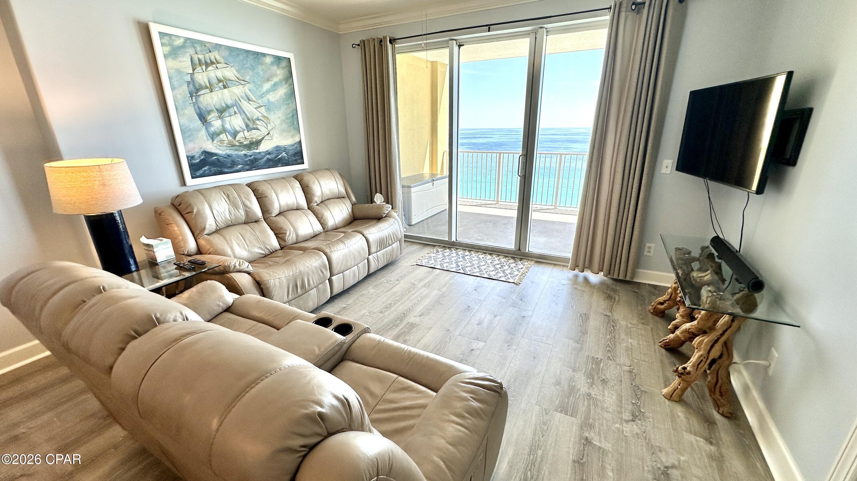 Welcome to Tropic Winds 1704 -- a beautifully renovated beachfront retreat that has never been rented and has been meticulously maintained. From the moment you step inside, you'll notice the care and attention that make this condo feel truly special.

Enjoy breathtaking, ever-changing Emerald Coast views from the open-concept kitchen, dining, and living areas, as well as from the spacious primary suite. The oversized 10' x 28' balcony offers plenty of room to relax, dine, and take in the sights and sounds of the Gulf. Whether you're enjoying morning coffee, outdoor dining, or a spectacular sunset, no two days are ever the same.

Renovations completed in May 2026 include a fully remodeled kitchen, updated primary and guest bathrooms, and luxury vinyl plank flooring throughout. An assigned covered parking space located under the building provides added convenience and easy elevator access.

The updated kitchen features quartz countertops, freshly painted cabinetry inside and out with soft-close doors, new (purchased in 2025) Whirlpool stainless steel appliances. A new dining table and chairs perfectly complement the coastal design and inviting atmosphere.

The living area is designed to maximize comfort and views, featuring a three-pane balcony door that fills the space with natural light and stunning Gulf scenery throughout the day. An electric reclining leather sofa and loveseat create the perfect place to unwind, watch a movie, or simply listen to the waves roll in.

The primary suite offers private balcony access, beautiful Gulf views, and a spacious ensuite bathroom with a new walk-in shower, comfort-height toilet, raised vanity, and updated countertop. The guest bedroom is generously sized to accommodate either one king bed or two queen beds and includes private access to the guest bathroom. The guest bath has also been recently updated with a tiled shower/tub surround, updated comfort-height toilet, raised vanity, and new countertop. Both bedrooms feature an adjustable power bed base and upgraded extended closet doors for added comfort, functionality, and storage.

Additional features include a laundry room with a stacked Samsung washer and dryer (2020), shelving for extra storage, and major system updates including an A/C unit and hot water heater installed in January 2021.

Tropic Winds offers approximately 330 feet of beachfront property and an impressive selection of amenities, including optional beach chair service, a seasonally heated indoor/outdoor pool, hot tub, steam room, sauna, fitness center, charcoal and gas grills, and a spacious Gulf-front paver patio with Adirondack chairs and chaise loungers.

Located on the desirable west end of Panama City Beach, Tropic Winds is just two miles from Pier Park's shopping, dining, and entertainment district. Nearby conveniences within walking distance include Alvin's Island, Mike's Oyster Bar, a convenience store, and the iconic Thomas Donut & Snack Shop and Thomas Pizzas & Cream. Just seven miles west, you'll find the scenic 30A and Rosemary Beach areas, offering even more upscale shopping and dining options at 30Avenue.

This non-smoking condo has never had pets and is truly move-in ready. Schedule your private showing today and experience beachfront living at its finest. Buyer to verify all measurements and square footage if important.  Some personal items do not convey, please inquire.