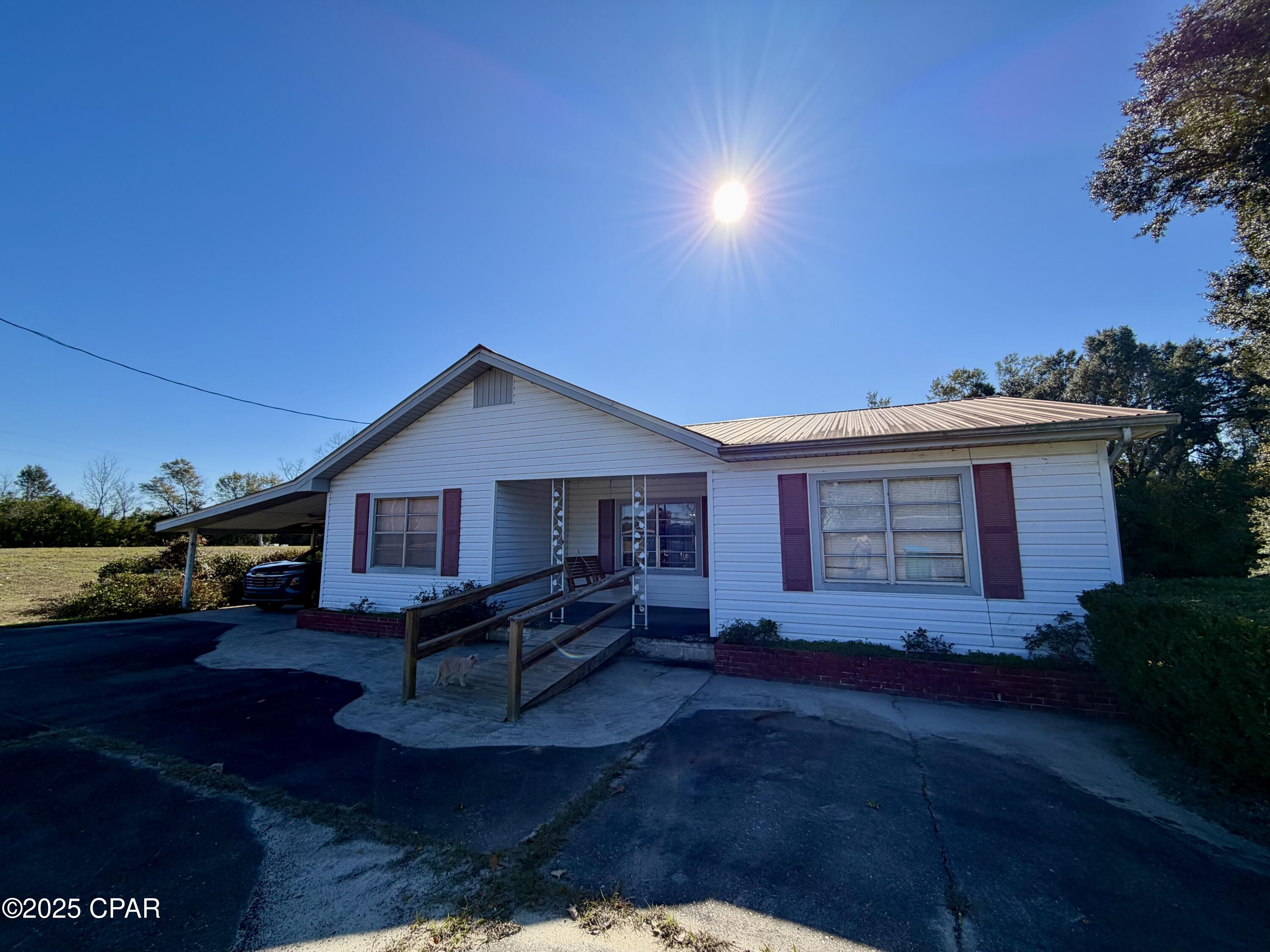 This home has been well loved by its current owner and is ready for you to fall in love with it, too! Offering 3 bedrooms, 2 baths, plus a versatile space that could be used as a home office, this property provides room to live, work, and grow.

The spacious living room features a built-in cabinet and counter with space for a fryer—perfect for hosting fish fries and gatherings. The dining room opens seamlessly to the kitchen, which boasts solid wood cabinets.

If you enjoy canning or gardening, you'll love the oversized utility room, complete with a sink, large work table, shelving, and space for a stove—ideal for processing homegrown vegetables.

The home features central heat and air, along with window units for added convenience. Original gas heaters add nostalgic charm but are not currently connected.

Situated on a corner lot with ample room for a garden, the property includes a tall carport with sides and a concrete floor for storage, plus a two-car carport attached to the home. Relax on the front porch swing and enjoy the peace and tranquility of country living.

If you enjoy hunting or fishing, you'll love the location. The 8,000-acre Apalachee Wildlife Management Area—offering public hunting land—is just minutes away. Lake Seminole, renowned for its premier fishing, is also close by. This property would make an ideal hunting or fishing cabin, or the perfect weekend getaway.

With endless potential, this home is ready for your personal touch!