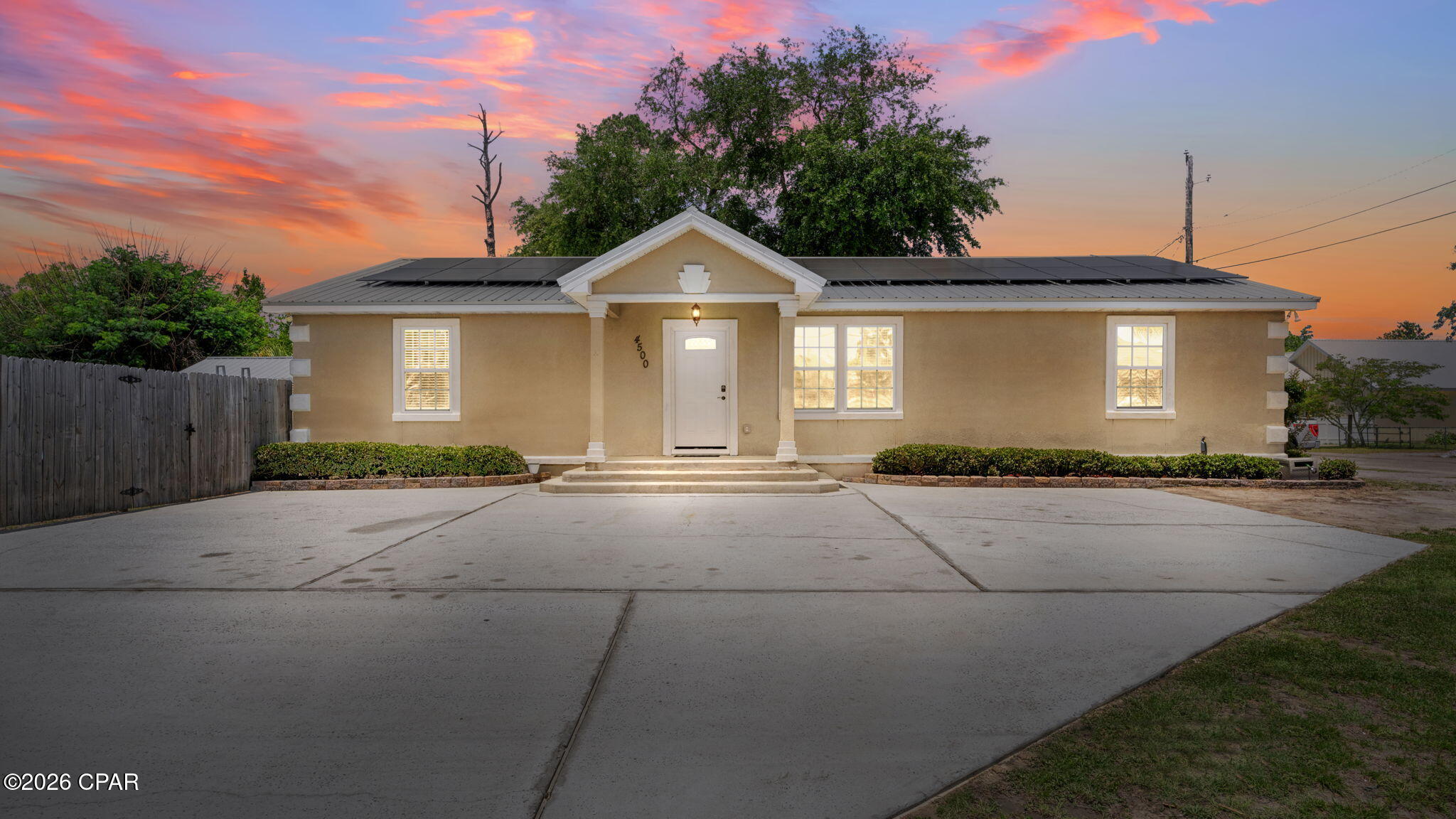 Welcome to this well-maintained 5-bedroom, 3-bath home offering over 1,900 square feet of versatile living space with a desirable split floor plan. A standout feature of this home is the rear bedroom with its own full bathroom and private exterior entrance--ideal for guests, extended family, or potential rental income. Don't let the exterior fool you--this home opens up into a spacious and functional interior that feels larger than expected. The layout features two bedrooms on one side of the home off of a front hallway, a private primary suite off of the living area, an additional bedroom off of the kitchen, and the private studio (bedroom with private bathroom) at the back of the home off of a hallway as you leave the kitchen to head out to the back deck space.

As you enter the home, you're welcomed into a spacious living area that flows seamlessly into the dining space and kitchen, creating an open and functional layout ideal for both everyday living and entertaining. The thoughtfully designed layout maximizes every square foot, offering functional living space with no wasted areas. The interior features textured walls for a more finished look, along with updated vinyl plank flooring.

The kitchen offers ample counter space, a pantry, and stainless-steel appliances, while a large laundry room adds extra convenience.

The spacious primary suite includes a large walk-in closet and an en-suite bathroom featuring double vanities, a walk-in shower, soaking tub, and a private toilet closet.

Major updates provide peace of mind, including a metal roof and a fully replaced HVAC system within the past 3 years, along with fresh interior paint and updated flooring in the majority of the home!

Situated on a desirable corner lot with a city park directly across the street, this home is conveniently located just minutes from the Hathaway Bridge, Florida State University Panama City, and Gulf Coast State College. Enjoy quick access to St. Andrews Bay with nearby boat ramps and waterfront recreation.

The fully fenced backyard features a 21-ft above-ground pool with partial in-ground installation, a surrounding deck, additional back deck space, and a large 25x10 enclosed shed. The property also offers ample parking for up to 6 vehicles, including space to accommodate a boat or trailer--perfect for enjoying the nearby water access.

The home also includes an installed solar energy system, offering long-term energy efficiency and consistently low utility costs.

This home offers space, flexibility, major updates, and an excellent location--ready for its next owner to make it their own.