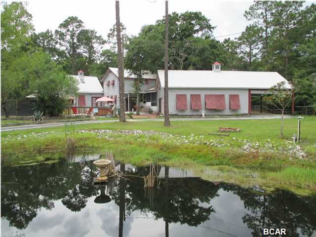 Looking for a place to raise and train your own horses and still be 10 minutes from the Mall. Look no further than this place. It has 2.39 acres with a 2 stall barn, feed and tack room and a stocked pond with catfish and coy. It is completely chain link fenced with a security gate at the entrance. Home features 6 bedrooms and 4 baths with 3000 sq feet of living space. As you enter your new property you will notice the long winding drive that continues past the pond to the home. The pond has a board walk to a gazebo where you can sit out and fish or enjoy many sunsets to come. The driveway completely encircles the home for easy access to the carport and the barn. The home features 6 bedrooms and 4 full baths. The kitchen has been completely remodeled with granite counter tops, soft close drawers, pot and wine racks in the ceiling, a pantry that has fold out shelving for more space, bamboo flooring and much more. The family room is tiled with 10 ft ceilings and the master bedroom suite has the 10 ft ceiling as well. The master bedroom has includes a large walk in closet with a spiral stairwell that leads up to a 8 X 39 heated and cooled carpeted bonus/game room that is not included in the sq footage of the home. The master bath suite is 15 X 18 with sliding Japanese Shoji paper doors with slate tile floors, tiled separate shower and an oversized whirlpool tub. This home has the wide plank laminate wood flooring throughout. All the rooms are large and storage space is everywhere and includes an indoor workshop within the laundry area. The Florida/dining room off the kitchen has a full wall of windows from floor to ceiling. This makes it possible to enjoy the outdoor views while in the heated and cooled comfort of your home. Most all of the rooms in the home are protected by a Fire Suppression/sprinkler system . Home has an in ground pool with a new in 2014 pool pump and filter. The home includes 2 HVAC systems, 2 washers and 2 dryers that convey with the sale, 2 hot water heaters and is under a termite bond. Make your appointment to see this unique property today. Too many amenities to list. Seller offering up to $10,000.00 in buyers closing cost and prepays with acceptable offer