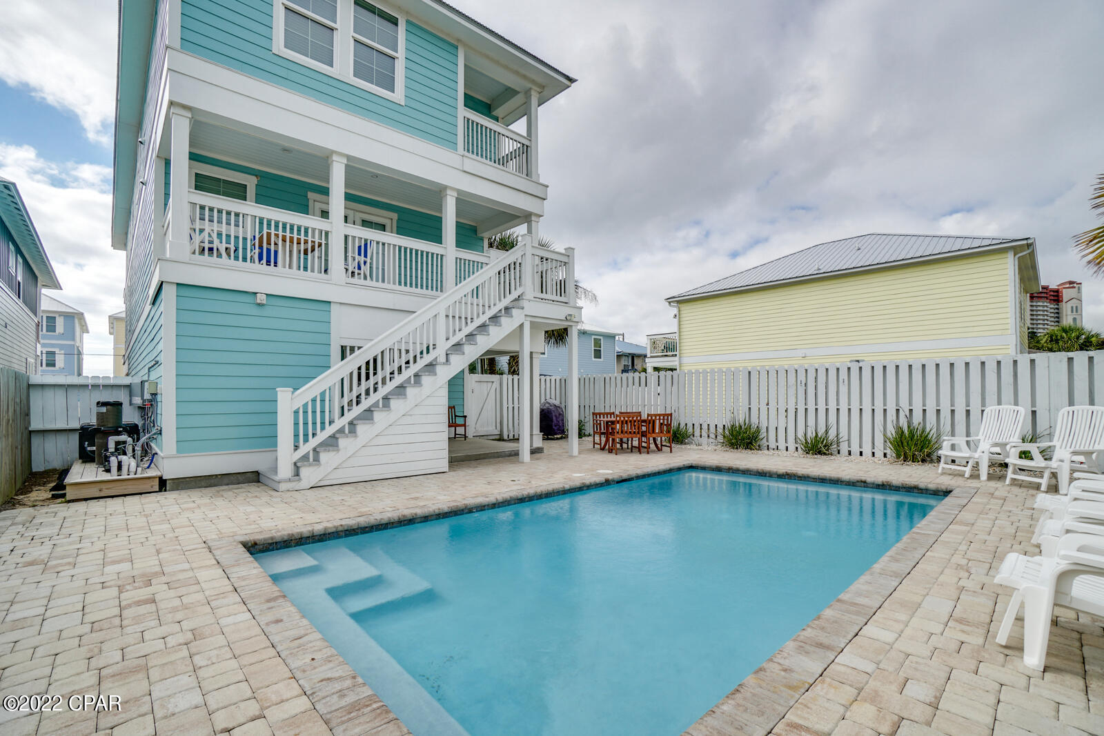 CURRENTLY UNDER CONTRACT. SELLER ACCEPTING BACK UP OFFERS.  ''JUST BEACHY'' is the perfect answer for Beach Lovers! Location...location....This one is directly across the street from the beach.... 20 STEPS To Sugar White Sand and Emerald Waters!  This 7 bedroom with 6 full baths & 2 half baths, Large open living/dining/ kitchen area, game area, covered patio and PRIVATE HEATED POOL, offers generous space for family and friends to gather, relax and make great memories! Plenty of parking with both covered and open driveway parking.  Fully furnished and ready to go....A great investment whether a primary residence, second home or rental.  Come visit today.......You will not want to leave!!