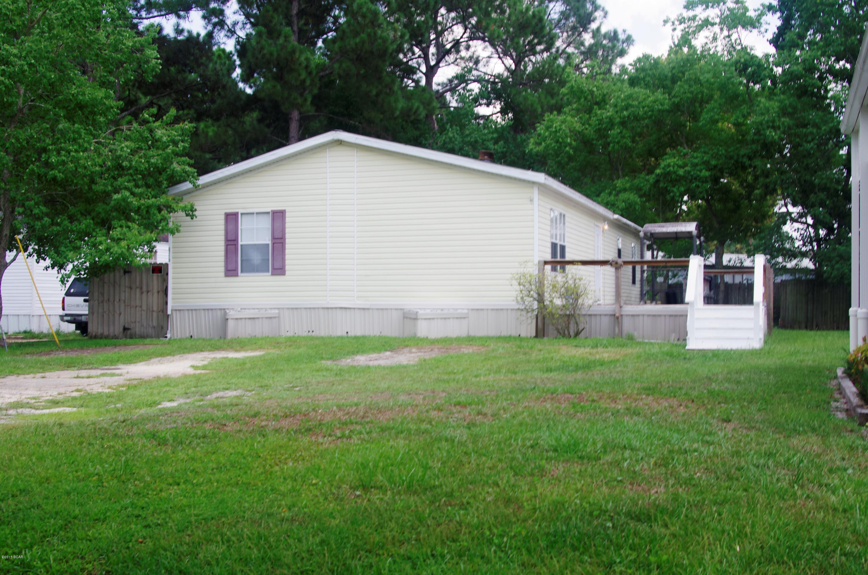 Super clean, good looking and well taken care of double-wide mobile home located just down the street from the Bayside Marina which is a full service marina with  boat launch. The home features 3 large bedrooms, 2 large baths and a huge living room. The master bedroom even has a walk in closet. The kitchen is well appointed with an all black appliance pkg. that looks brand new. The ceiling is vaulted and crown molding runs throughout the home. The large yard is partially fenced (6'wood) for pets and there is a huge deck out front for entertaining or just relaxing after a hard day of fishing. Come and see today.