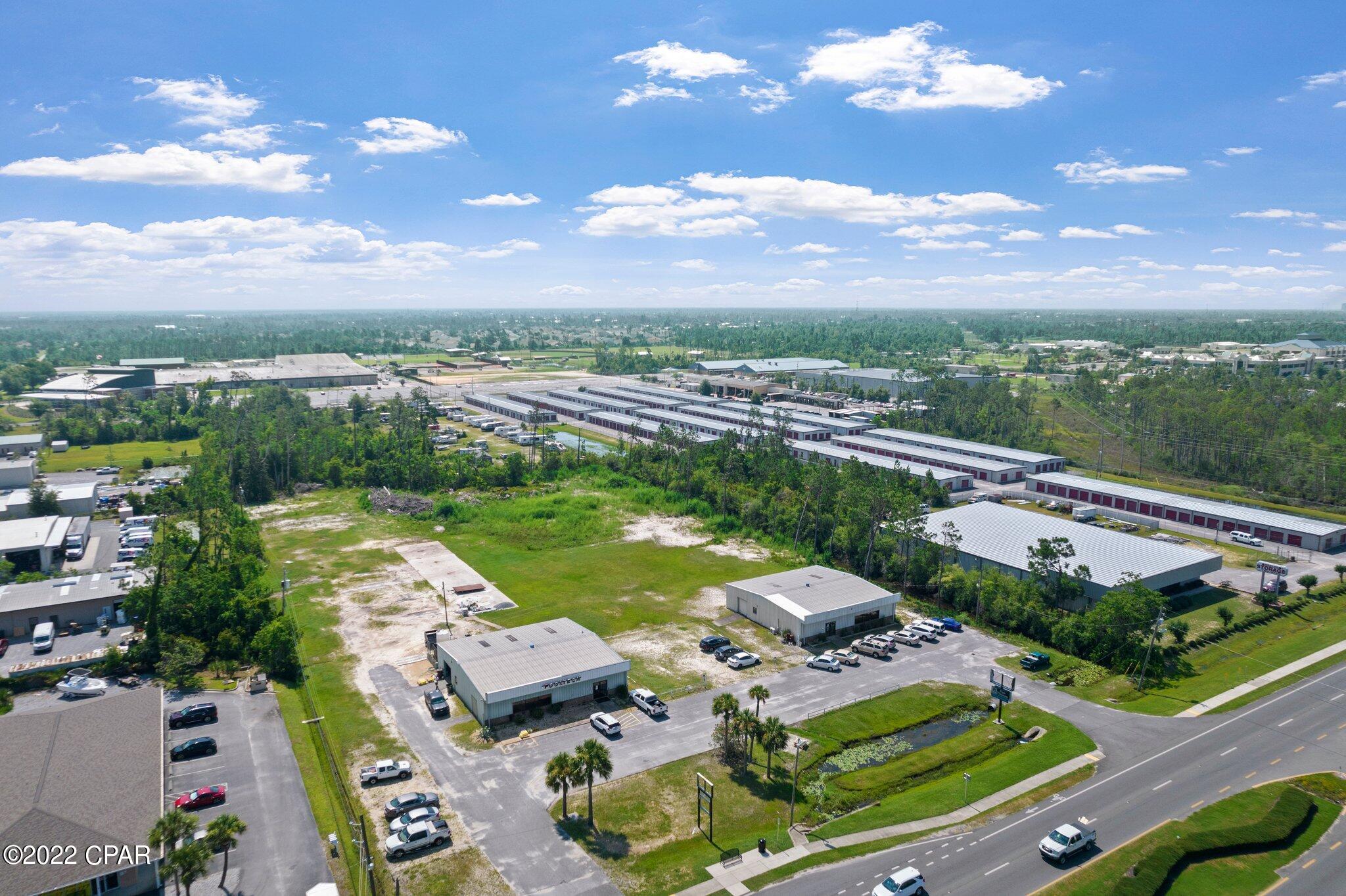 Owners will divide!  Desirable 4.2 acre property located on busy Hwy 77 in Panama City.  There is 330' of road frontage on Hwy 77 with ingress and egress in two locations. Annual average daily traffic count is 30,098 vehicles.  The property consists of two metal 60' x 60' retail buildings complete with finished interior space and covered warehouse storage.  There is parking at each building and a driveway between.  There is no direct cut in the median at this location, but the cut is very nearby so turning in from the opposite side of the road is fairly easy.  The back portion of the property is vacant land except for a cement slab where an additional storage building used to be.  The sellers retail business is not for sale only the buildings and property.  The other business onsite is in a month to month lease.  Please do not disturb these tenants.  The property has a Panama City address but was annexed by the city of Lynn Haven, so utilities and taxes are through Lynn Haven.  Lots of potential with this size lot for teardown and redevelopment as Office, Hotel, Retail, Restaurant, Multi-Family, etc.  Sellers will consider owner financing with 20% - 25% down and a 5 year balloon.