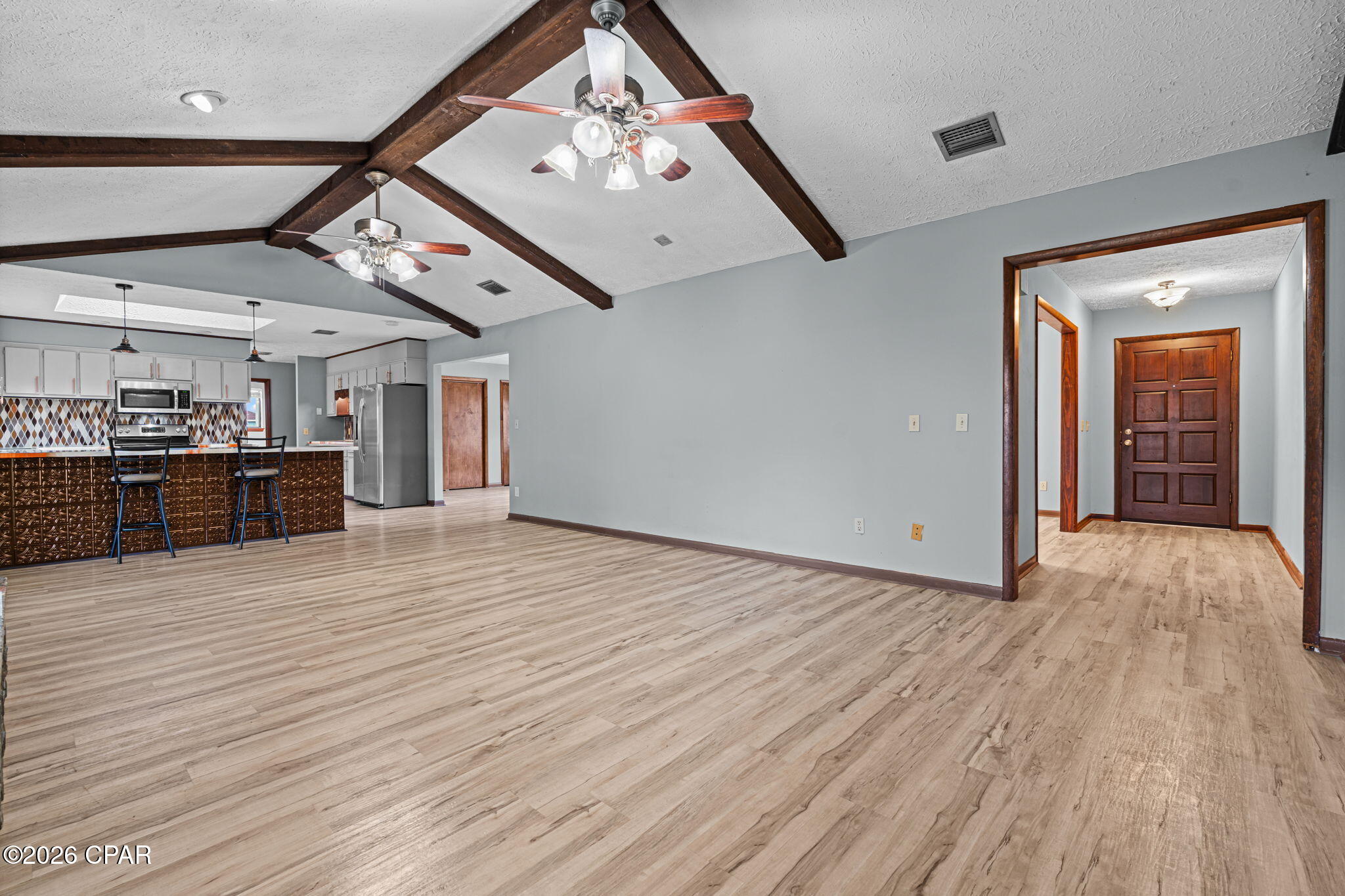 Spacious 3-bedroom, 3.5-bath home in desirable Kings Point featuring nearly 2,500 sq. ft., a large office, oversized rooms, and a split-bedroom floor plan. Enjoy a private fenced backyard with a covered patio, pergola, fire pit, hot tub, and workshop. Additional features include a wood-burning fireplace, stainless steel appliances, luxury vinyl plank flooring, an oversized garage, and an updated roof, HVAC, and water heater. Conveniently located near shopping, dining, bay access, and just a short drive to Panama City Beach. Property also available for rent for $3,000 a month.