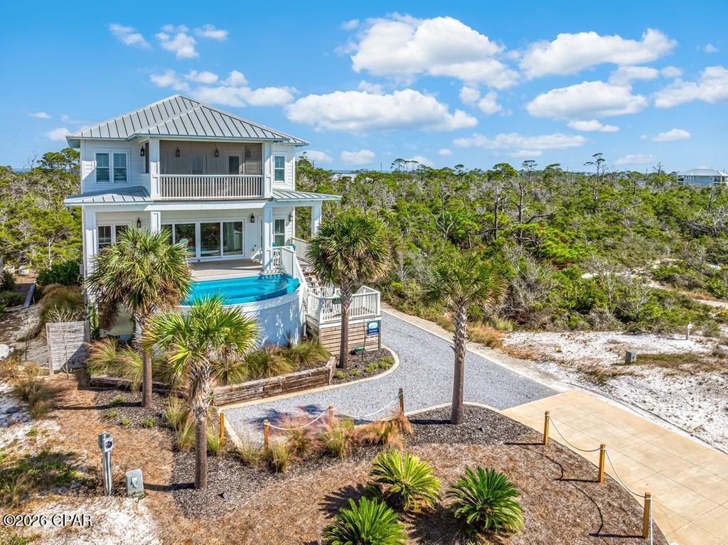 1ST TIER BEACH HOUSE in X FLOOD ZONE W/ UNOBSTRUCTED VIEWS - featuring an INFINITY POOL that blends into the gulf horizon! Situated in a prime location, this remarkable first-tier residence has exceptional panoramic views and offers a plethora of custom features. An elevator provides easy access to all levels, ensuring convenience for you and your guests. This home's spacious open-concept floor plan is perfect for both casual living and entertaining. The chef's kitchen features top-of-the-line stainless steel appliances including: A 6-burner gas stove with pot filler, double oven, ice machine, granite countertops, and a large island that serves as the heart of the home. The kitchen seamlessly flows into the dining and living areas, where you can enjoy the coastal breezes and an abundance of natural light. With four spacious bedrooms this house provides comfort and privacy for all of your guests. Upstairs features a custom wet bar, adding an elegant touch of sophistication and convenience. The primary suite is a true retreat, with its own private deck, sweeping gulf views, and an en-suite bath with a walk-in shower. Outside, you'll discover a beautifully landscaped backyard oasis featuring a stylish pergola with paver flooring and a cozy fire pit surrounded by outdoor seating. This area is perfect for relaxing under the stars. Whether you're seeking a private family retreat, an income-generating vacation rental, or simply a place to relax — this property has it all. Escape to one of Florida's most beautiful and secluded areas! Don't miss your chance, schedule your tour today! This is a MUST SEE!