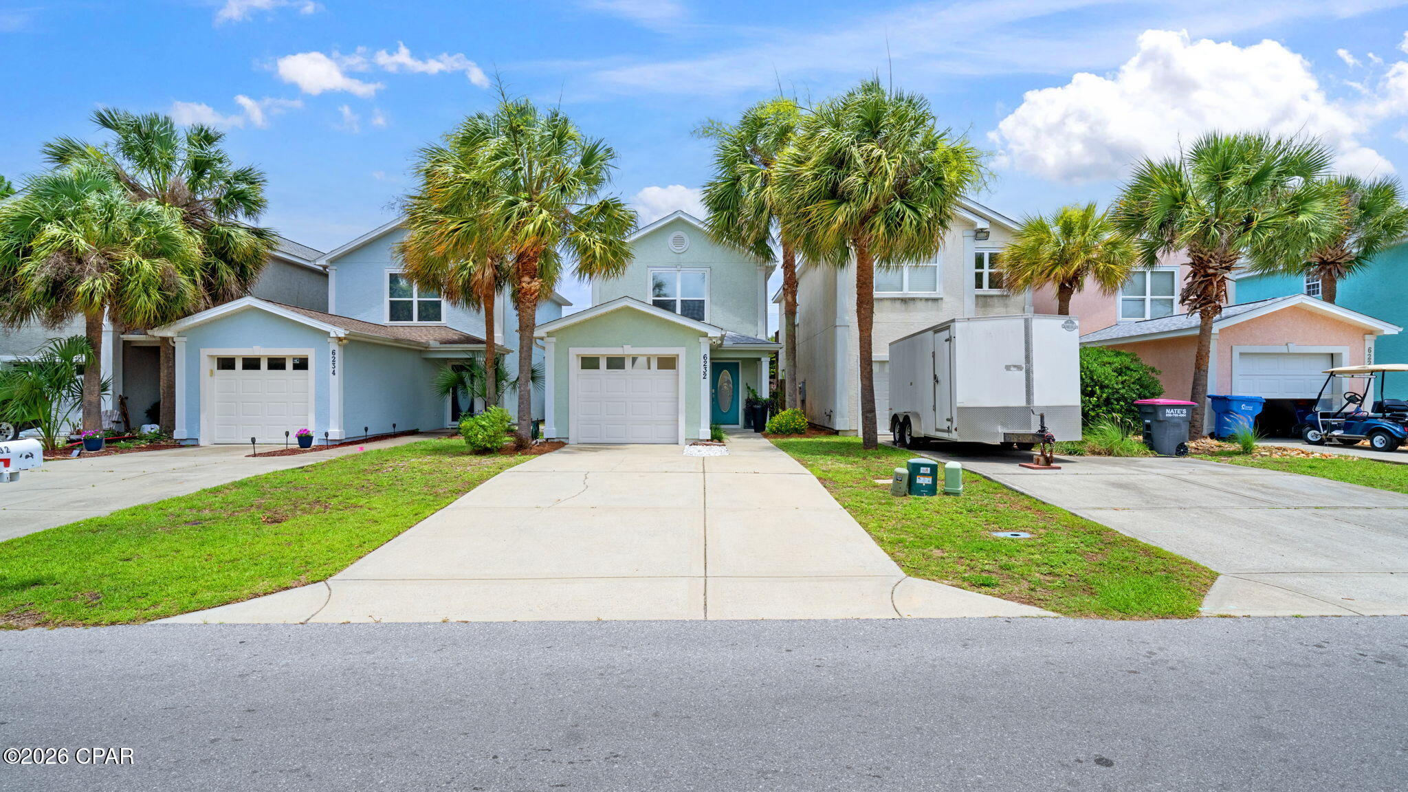 COMPLETELY RENOVATED BEACH STUNNER!  Every detail has been reimagined to create a modern, warm, move in ready experience!  Lovingly cared for and no detail left out, completely redone in 2026.  Feel the warmth of high end LVP flooring in warm inviting tones throughout.  The clean smooth ceilings highlight all new recessed lighting with designer fans and crystal pendants and dining fixtures complete with dimmers. The kitchen boasts undercab lighting with cool to warm CCT color switch to choose your mood. The chefs kitchen features top of the line quartz countertops, new sink, faucet and stunning Spanish tile backsplash. Upstairs is no exception with gorgeous wood beams on the landing ceiling, a completely renovated bathroom with linen closet and lighting fixtures in master and second bedrooms.  The expansive balcony off of the Master Bedroom overlooks the luscious backyard for easy relaxing with coffee or your favorite beverage.  The backyard is full of edible fruit trees to include: pomegranate, apple, avacado, grapefruit, banana, loquat and peach!  Off of the grilling porch downstairs, there is a raised vegetable garden as well! A Ring camera with flood lights and doorbell camera will protect your piece of paradise.  All of this and only 5 minutes away from Grand Lagoon, wonderful restaurants (like Captain Andersons, Deckhand Social and Grand Marlin), grocery stores and shopping!  Don't miss this beauty.  Call for your personal showing today.