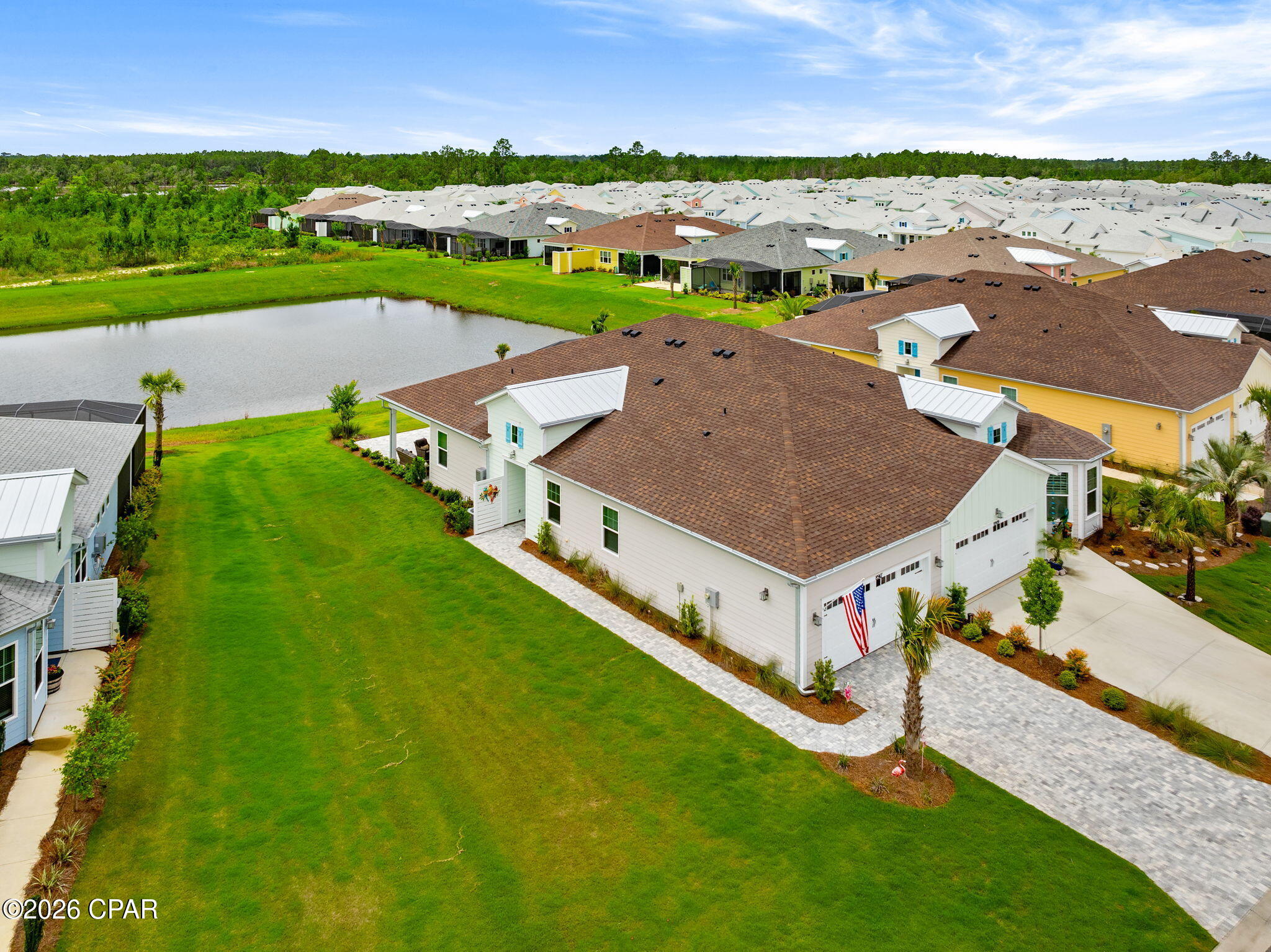 Rare opportunity to own an Antigua Villa on one of the most desirable homesites in Latitude Margaritaville Watersound! Perfectly positioned on an oversized lot with both pond and preserve views, this exceptional property offers the rarest combination of privacy, nature, and water views. Located on a quiet cul-de-sac street in highly sought-after Phase 6BC, you'll enjoy breathtaking sunrises, colorful sunsets, and abundant wildlife right from your backyard.

This beautifully maintained villa features numerous upgrades, including wood-look tile flooring throughout in a light coastal color, designer lighting and ceiling fans added after closing, custom interior paint, upgraded cabinetry, granite countertops, a 40/60 sink, and an upgraded electric induction range with Air Fry capability. The open-concept design creates an inviting space for everyday living and entertaining.

The spacious primary suite offers a luxurious bath with a tiled walk-in shower and frameless glass enclosure. Secondary bedroom with adjacent bath. Den/Office flex or additional guest space. 

Enjoy Florida's outdoor lifestyle from the covered lanai and extended paver patio overlooking the tranquil pond and preserve. The paver driveway, entry walkway, and lanai have all been professionally sealed, and two Polywood sunbathing chairs with cushions will remain.

Additional features include sealed interior tile flooring, 8-foot interior doors, hurricane shutters, a hurricane-impact glass front door, polyurethane-coated garage floor, attic stairs with additional storage space, and T-6 wiring throughout with wood blocking installed during construction for easy TV mounting.

Enjoy added peace of mind with the remaining 2-10 structural warranty from the original build date. Villa HOA dues include scheduled roof replacement and exterior repainting on a maintenance schedule.

Residents enjoy the award-winning Latitude Margaritaville lifestyle with a full service 2 story restaurant, resort-style pool, fitness center, pickleball and tennis courts, walking and biking trails, live entertainment, clubs, social activities, and the popular Flip Flop Square located just steps away in phase 6bc, featuring tiki hut pavilions, grills, and expansive green space for neighborhood gatherings and events.

Conveniently located approximately 7 miles from the sugar-white beaches of Panama City Beach, the community is also near the future Publix-anchored shopping and dining district, currently under-development, and the future medical campus and hospital corridor, making this one of the most exciting areas along Florida's Emerald Coast.

Experience resort-style living, spectacular views, and one of the most unique homesites available in Latitude Margaritaville Watersound.