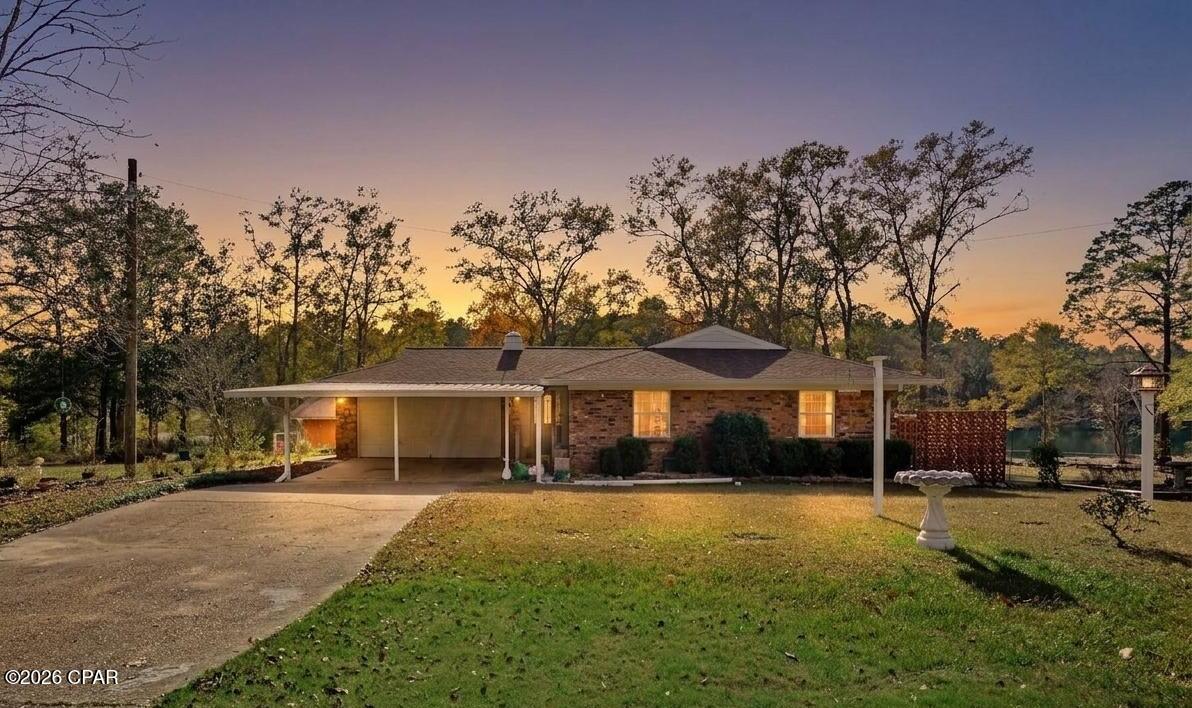 CURRENTLY UNDER CONTRACT, SELLER WILL CONSIDER BACKUP OFFERS
Welcome to your private waterfront retreat in the charming community of Dogwood Lake Estates--where space, versatility, and scenic beauty come together.

Situated on approximately 1.37 acres +/-, this well-maintained brick home offers 3 bedrooms and 2 bathrooms with a flexible, multi-level layout designed to accommodate a variety of lifestyles. Whether you're looking for a primary residence, multi-generational living, or income-producing potential, this property delivers.

Upstairs, you'll find a thoughtfully designed semi-open floor plan featuring a well-appointed kitchen that flows seamlessly into the dinette and living area--perfect for everyday living and entertaining. Two spacious bedrooms and a full bath complete the upper level. French doors lead out to an expansive deck overlooking the lake, offering a peaceful setting for morning coffee or evening relaxation.

The lower level expands your living options with a fully functional second living space. Complete with its own private entrance, this area includes a large living room with a fireplace, a second kitchen, a third bedroom, and a full bath. French doors open to the backyard, creating an ideal setup for guests, in-law quarters, or a potential rental unit.
Additional highlights include:

Attached garage conveniently located off the foyer, featuring built-in cabinetry, utility sink, and washer/dryer setup
Detached block building with garage door--perfect for workshop or equipment storage
Additional storage building near the water for all your lake gear
Expansive yard offering privacy, room to roam, and direct lake access

Located in the quaint and desirable Dogwood Lake Estates community, residents enjoy access to lakes, a golf course with clubhouse, and the added benefit of no HOA. All of this just a short 6-mile drive to Bonifay for shopping, dining, and everyday conveniences.

This is a rare opportunity to own a waterfront property with space, flexibility, and endless potential. Schedule your private showing today and experience lake living at its finest. Schedule your private showing today!