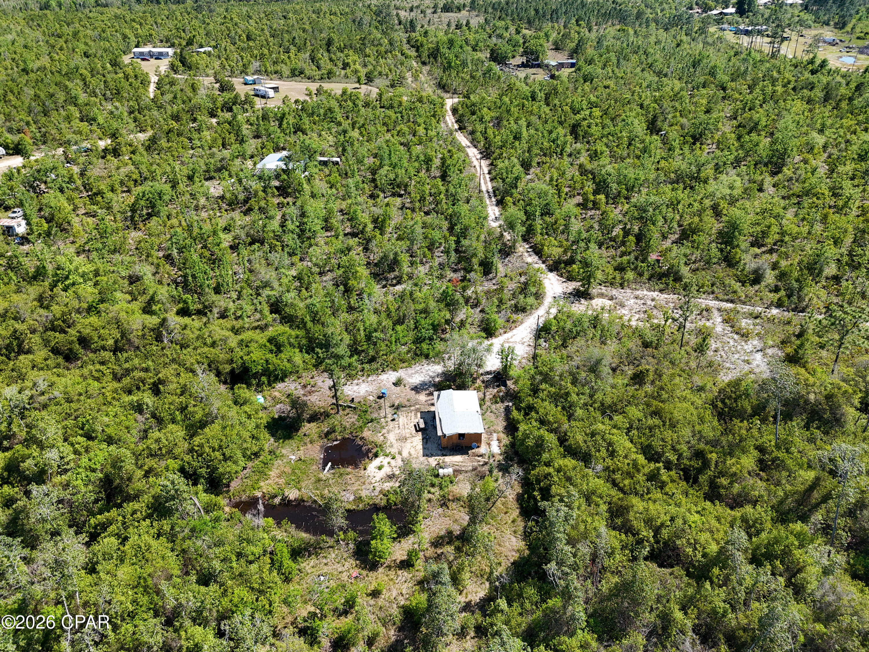 Country getaway! 10 secluded acres perfect for weekend camping, hunting, or fishing. The wooded parcel features a small pond and a creek runs through the property. Finish the building to have a great campsite. There is a well on the property and everything needed to put in a septic tank. So much opportunity!