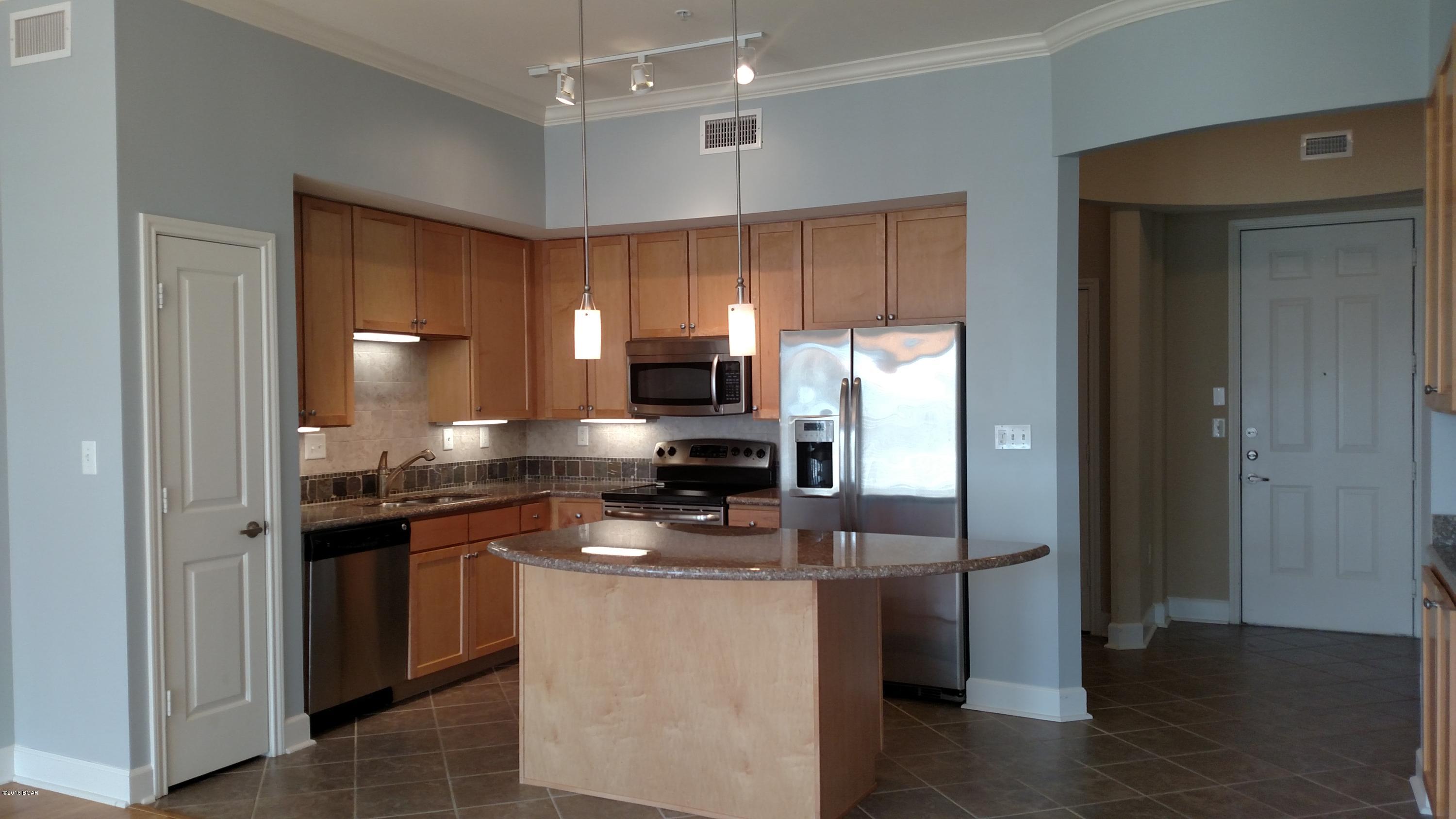 Move-In Ready with Courtyard/Pool Views. Experience an oasis at the beach. This is a 1 bedroom condo w/study. Features include hardwood flooring in the main living/dining area, tile in the foyer, hall, laundry, bath, and carpet in bedroom, walk-in closet and study. The well appointed kitchen includes granite island and countertops, stainless appliances, and wood cabinetry. This condo also has a washer and dryer, blinds throughout, private balcony, and covered entry. Bathroom boasts garden tub and dual vanities. Water, sewer, and garbage included. Pets are not allowed. Island Reserve is a highly-sought-after gated community loaded with amenities, including resort pool with zero entry and waterfall, indoor sports court, fitness center, gameroom and theater.