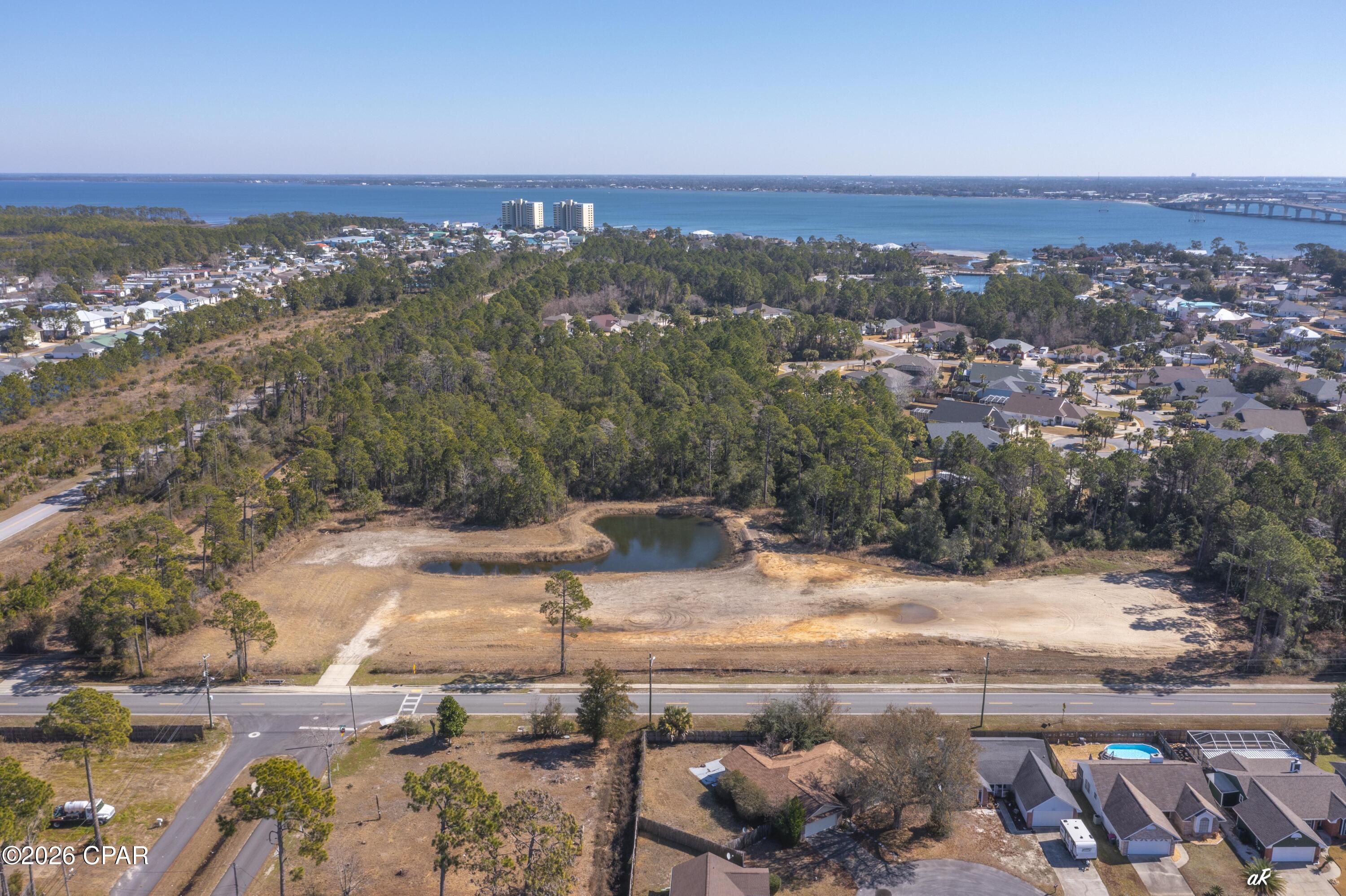 Location, Location, Location!  Beautiful 10.9 acres in Residential Area of Panama City Beach, just across the Hathaway Bridge and near the intersection of Thomas Dr and Middle Beach Road and Panama City Beach Parkway. This property is located in Bay County zoning area, zoned R3.  There are plans and drawings available from previous DO.  The site has approximately 5+ acres for development according to current plans, however ''new'' plans could possibly include more acreage for development with higher density.