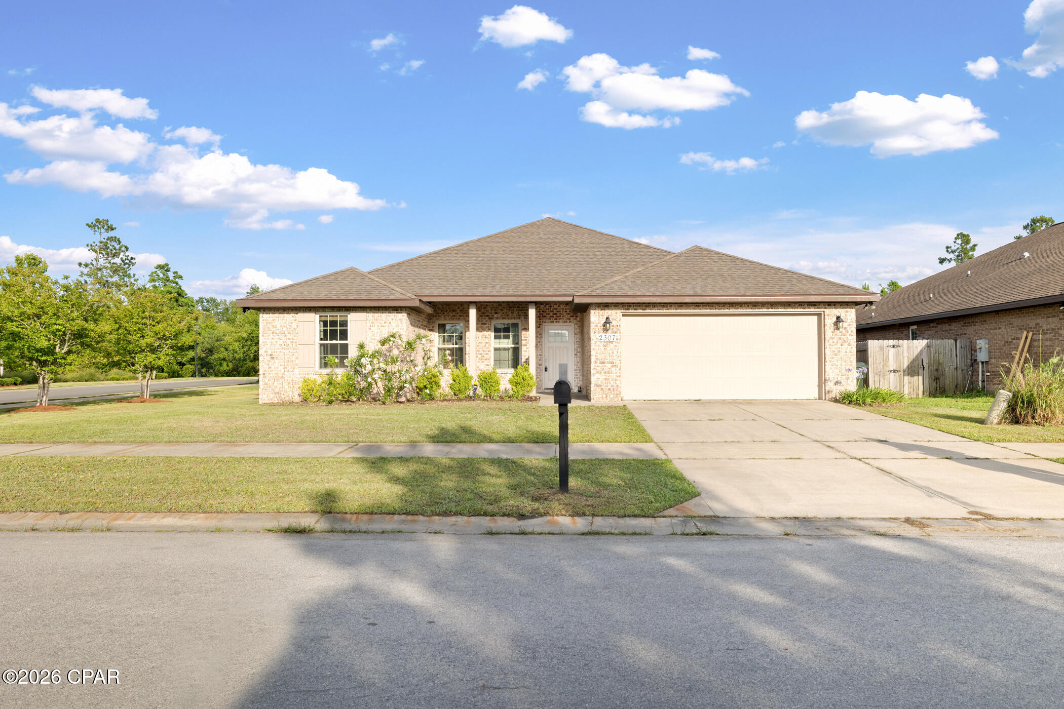 Welcome to 2307 Dragonfly Lane, a beautifully upgraded 4-bedroom, 2-bath home situated on a spacious corner lot in the highly desirable Camryn's Crossing community in Panama City. Built in 2017, this thoughtfully designed home offers 1,876 square feet of open-concept living with a split-bedroom floor plan that perfectly blends comfort, style, and functionality.

From the moment you step inside, you'll notice the abundant natural light and elevated finishes throughout, including tile plank flooring, shiplap accent walls, and tray ceilings in both the living room and primary suite. The seamless open layout creates the perfect atmosphere for everyday living and entertaining alike.

The kitchen is the heart of the home, featuring shaker cabinetry, granite countertops, stainless steel appliances, recessed lighting, and a spacious island overlooking the dining and living areas.

The private primary suite offers a relaxing retreat with dual closets and a spa-inspired bathroom complete with a tiled walk-in shower and deep soaking tub. Additional bedrooms are generously sized with ample closet space and flexibility for guests, kids, or a home office.

One of the home's most unique features is the fully heated and cooled convertible garage with mini-split system, creating an ideal flex space for a home gym, office, playroom, media room, or bonus living area.

Step outside to enjoy the fully fenced backyard and screened-in porch with TV hookups...the perfect setup for football weekends, family gatherings, or quiet evenings outdoors year-round.

Even better, this home comes with a low HOA and no flood insurance requirement, offering added affordability and peace of mind.

Conveniently located near schools, shopping, dining, and just a short drive to the beautiful Gulf Coast beaches, this move-in ready home truly offers the best of Florida living.