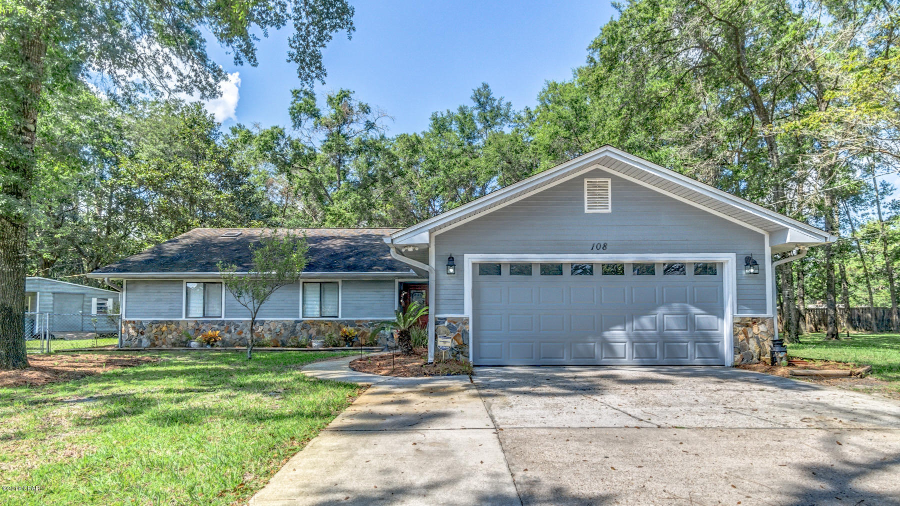 ATTRACTIVE COLLEGE POINT HOME ON CUL-DE-SAC. The interior features 4 Bedrooms, 2.5 Baths, an open floor plan with a large remodeled kitchen and dining area, an XL living room with wood burning fireplace, beautiful tongue and groove wood raised ceilings throughout most of the home, an interior laundry room with cabinets and a 2 car garage. The kitchen boasts a large breakfast bar, an island, a stylish back splash and stainless steel appliances. The master bedroom can accommodate king size furniture and has a fireplace, a walk-in closet, access to the backyard and an adjoining remodeled bathroom with a Whirlpool tub and a glass enclosed tiled shower.  All bedrooms are good size and one even has a loft reading nook with ladder above the closet.  New Carpet in the Bedrooms! This home also has a 12x18 Florida Room for additional living space. The floor plan is great for entertaining. The exterior features a 75x185 lot located at the end of the cul-de-sac, a mostly fenced backyard, a fenced side yard with workshop and attached carport, and a huge Tree House with a spiral tube slide. Great School Zone and located near public parks and boat ramps. No HOA. All information derived from seller and public record. Buyer to verify. Measurements approximate.