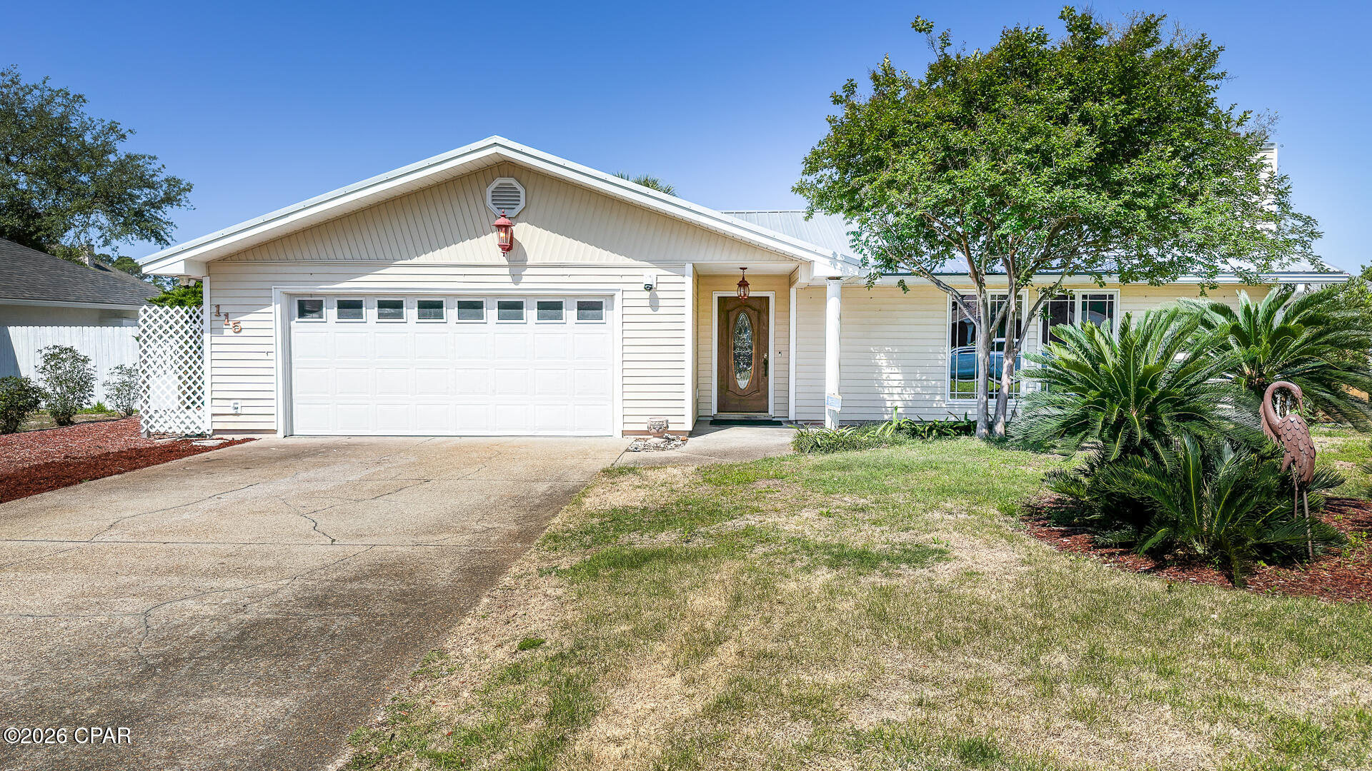 CURRENTLY UNDER CONTRACT, SELLER WILL CONSIDER BACKUP OFFERS. Enjoy peaceful living with easy access to everything Panama City Beach has to offer. This beautifully maintained home sits on a quiet cul-de-sac in the desirable North Lagoon Oaks neighborhood--just minutes from world-class beaches, marinas, shopping, dining, and the popular St. Andrews State Park. 
Built to last, this home features a brand-new roof, updated air conditioning system, new water heater, and a freshly painted interior. Step inside to a spacious living room with soaring ceilings and a cozy fireplace, open to the dining area. Double doors open onto a large deck overlooking your shaded, private backyard--perfect for relaxing or entertaining. The primary suite offers a private ensuite bath and direct access to the backyard. Both guest bedrooms are well sized, with a convenient hall bath. 
Outside, a majestic oak tree provides natural shade and charm, while a deluxe powered shed/workshop offers excellent storage or hobby space. Additional upgrades and features include a whole-house generator transfer switch, a private well for irrigation, a fully fenced yard ideal for pets and privacy, a double garage with attic access for extra storage, and a wide driveway that easily accommodates four vehicles. 
Best of all, there are no HOA fees and no flood insurance required. Whether you're seeking a primary residence, a second home, or a strong investment property in Panama City Beach, this move-in-ready home in an outstanding location is ready for you. Don't miss your opportunity--schedule a showing today!