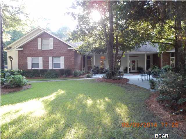 What a rare find in Panama City. This is a great neighborhood and a good school district. Very convenient location. This beautiful house sits on an acre of land. Over 6000 under roof. Natural landscape in the front with a circle drive. Mature trees which include 6 pecan. Sprinkler system with separate well. It has a detached workshop with a bathroom and outside shower with H/C water. A 220 plug for your motor home. Spend your time outside in the oversized pool or just sitting on your fantastic porch watching the children play on the playground. This house has a whole house generator and security system. Kitchen updated in 2011, new paint May 2014 and new hardwood flooring June 2014. Natural light throughout the house. Den with built in bookcase and awesome windows. Living room with