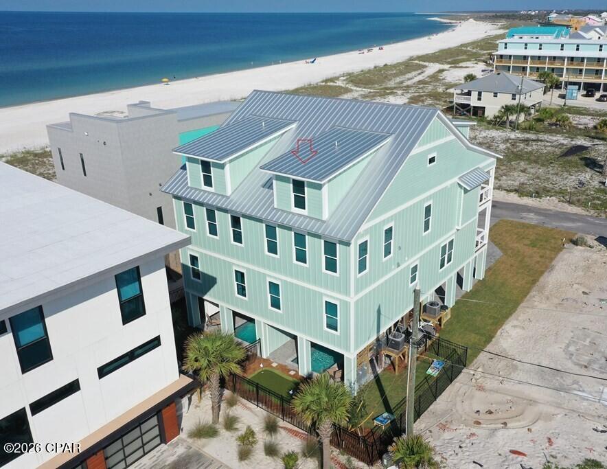 Established Rental Income! Fully Furnished and Rental Ready with 6BR/6.5B and 3,376 SF heated and cooled space. Unit A - That describes this luxury duplex built in 2023 and decorated to the nines. Located just one lot from the beach in Mexico Beach, FL and on the Beachside of Hwy 98. .LEVEL 1 - Foyer and half bath. LEVEL 2 - Spacious Living-Dining-Kitchen with Designer Furniture, granite countertops, stainless appliances, backsplash, wood cabinets, farm sink and one bedroom with en-suite bath. Also powder room and laundry on this floor. This floor has a covered porch with views of the beach and sunsets. LEVEL 3 - 3 bedrooms with en-suite baths. The covered porch offers a private space to catch a breeze from the Gulf. LEVEL 4 - Family recreational area (geared for the kids) and 2 additional bedrooms with one hosting 3 sets of bunk beds. Multiple laundry areas. Luxury amenities including a private heated cocktail pool, putting green, recreational area and covered patio space. This property has endless possibilities whether being a home, vacation home, investment property OR family retreat. Enjoy the miles of beach to explore and a magnificent sunset every evening. Restaurants and shops nearby. This property is Just Stunning!!