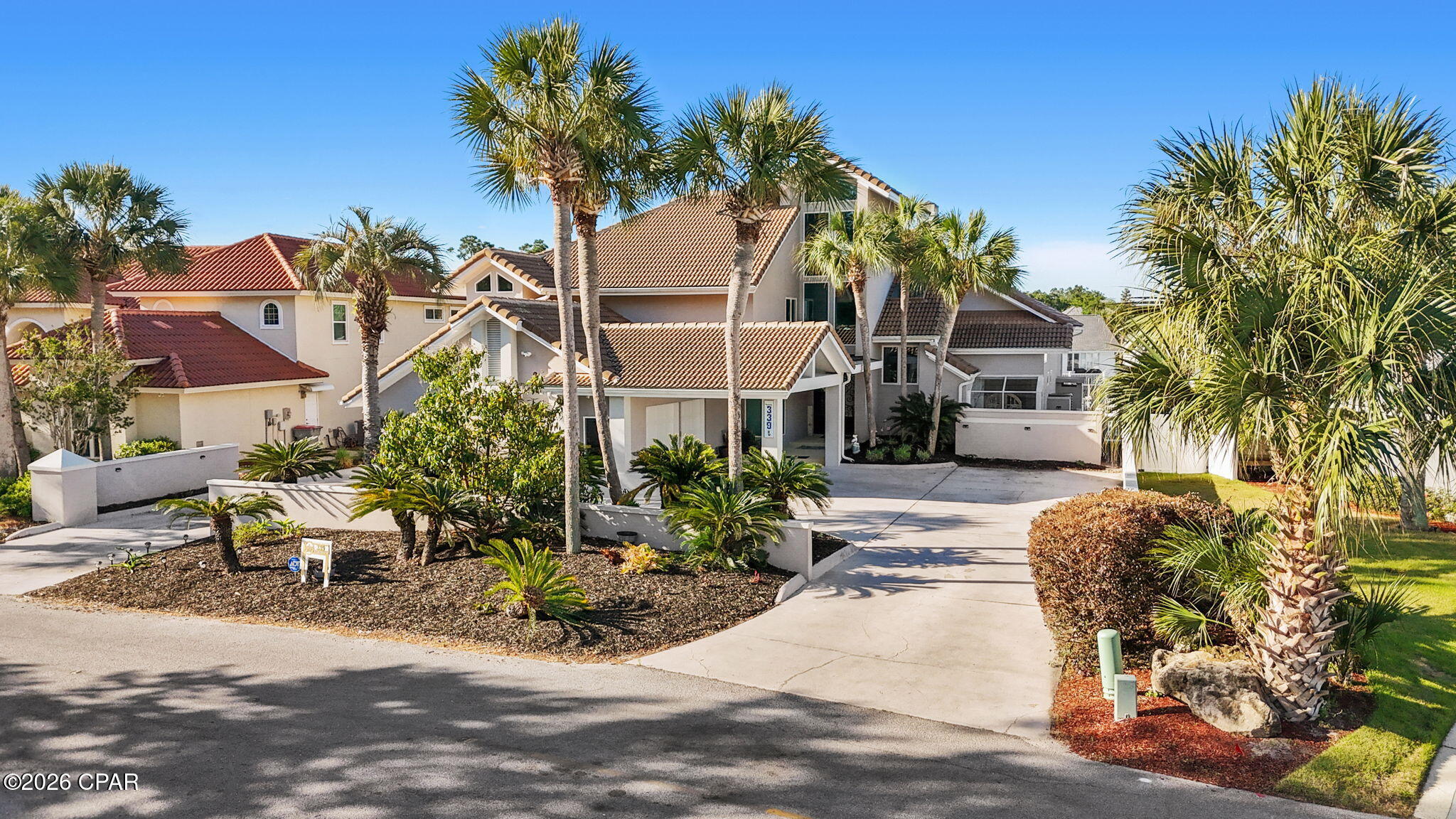 Step into refined coastal luxury with this extraordinary waterfront estate, perfectly positioned in the prestigious, gated Bay Point community. Offering 4,159 square feet of meticulously designed living space, this 5-bedroom, 5.5-bathroom residence blends timeless craftsmanship with modern elegance.  It is crafted for both relaxed living and unforgettable entertaining.

From the moment you enter through grand double French doors, you're greeted by soaring ceilings, abundant natural light, and exquisite imported Italian porcelain tile.  Custom teak wood accents with stunning blue ''water'' inlay create a subtle yet striking nod to the home's waterfront setting.

At the heart of the home lies a truly gourmet kitchen designed to impress even the most discerning chef. Featuring double ovens, dual refrigerators, a sleek cooktop, dishwasher, two wine fridges, custom cabinetry with a built-in buffet, and expansive granite countertops.  This space is both functional and breathtaking. A charming breakfast nook complements the formal dining area, while the open-concept layout effortlessly connects to the spacious living area which makes it perfect for hosting gatherings of any size.

The luxurious primary suite, located on the main level, is a serene sanctuary with sweeping views of the pool and canal, complete with a spa-like ensuite bath. For work or quiet retreat, the downstairs library/office showcases rich custom dark mahogany cabinetry and can easily serve as a fifth bedroom if desired, offering flexibility for guests or multigenerational living.  

Upstairs, three generously sized bedrooms each feature their own beautifully appointed bathrooms, ensuring comfort and privacy for family and guests alike.

Designed for seamless indoor-outdoor living, the home opens to an entertainer's paradise. Multiple rear access points lead to an expansive Trex deck featuring a sparkling pool, sun deck, hot tub, gas fire pit, and a fully equipped outdoor cooking area. A convenient half bath accessible from the pool area adds ease for outdoor gatherings, while a thoughtfully designed wet bar with wine fridge and ice maker provides seamless beverage service both inside and out.

Boating enthusiasts will appreciate the impressive 95-foot dock with deep water access, offering direct passage to open waters. Additional highlights include a spacious 2-car garage, impact-resistant doors and windows, and the peace of mind that comes with living in a secure, gated community.

This is more than a home; it's a lifestyle. Experience the pinnacle of waterfront living where luxury, comfort, and coastal beauty converge.