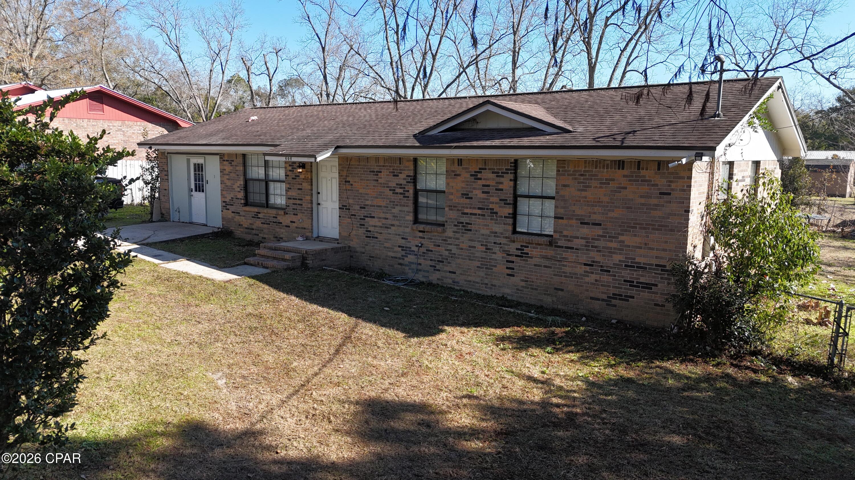 This charming 3-bedroom, 2-bath brick home in the heart of Bonifay, Florida, offers the perfect blend of small-town convenience and modern updates. With fresh paint, high-grade LVP flooring, a brand-new roof going on in just a couple of weeks, and a beautifully tiled master shower, the interior feels move-in ready and full of light. The converted garage now serves as a spacious den plus a dedicated laundry room, while the screened-in back porch and fully fenced backyard (complete with a large storage shed) provide wonderful outdoor living space for relaxing or entertaining. Situated on a paved city street, you get the best of both worlds—peaceful neighborhood living with easy town access, yet you're only about 45 minutes from the sugar-white sands and emerald waters of Panama City Beach. It's a solid, well-cared-for home that's ready for someone to love and enjoy for years to come!