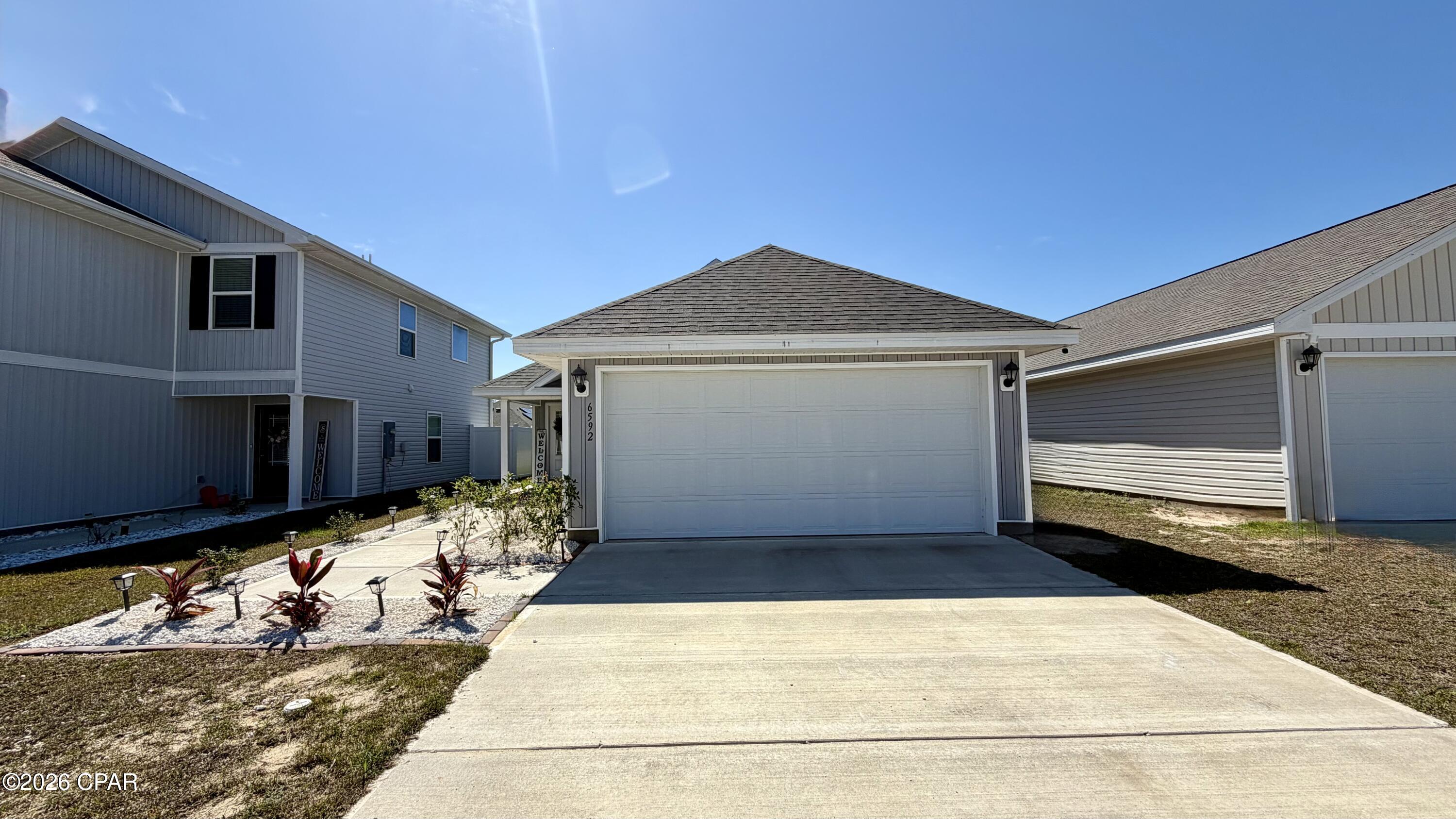 Set in the Liberty subdivision of Panama City, this 3-bedroom, 2-bath home offers an open floor plan with an open kitchen and stainless appliances, ideal for everyday living and entertaining. Carpeted bedrooms provide comfortable private spaces, and the master bedroom includes a soaking tub for a relaxing soak. Practical features include a laundry room and a two-car garage. Residents have access to community amenities including a center with a gym/wellness room, plus a pool and splash pad.