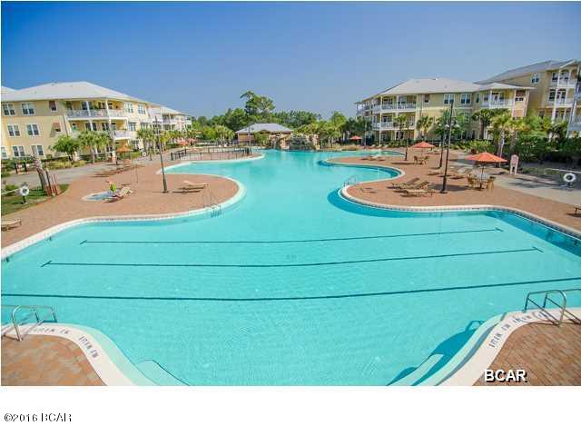 Experience an oasis at the beach. A 1 bedroom, 1 bath, 1071 sq. ft. condo with a study/office in the beautiful and tranquil gated community of Island Reserve, located off Front Beach Road in Panama City Beach. This open floorplan features hardwood flooring in the living area, tile in the kitchen and bathroom, and plush carpet in the bedroom and bonus study, all with 10' ceilings. The well appointed kitchen includes granite countertops and island, stainless steel appliances, and wood cabinetry. Condo amenities include washer and dryer, window coverings, private porch and covered garage parking and entry. Water, sewer, and garbage are included. Pets are not allowed. Island Reserve amenities include game room, fitness center, indoor sports court and resort style pool. The Island Reserve community features gorgeous landscaped courtyards with paved walks and fountains. Club house boasts fitness center, media center, indoor basketball court, aerobic/fitness center, and game room/community room. And don't forget one of the largest residential swimming pools in Northwest Florida, almost 1 acre complete with lap area, water fountain, waterfall and hot tub. It is truly an island in the middle of the beach.