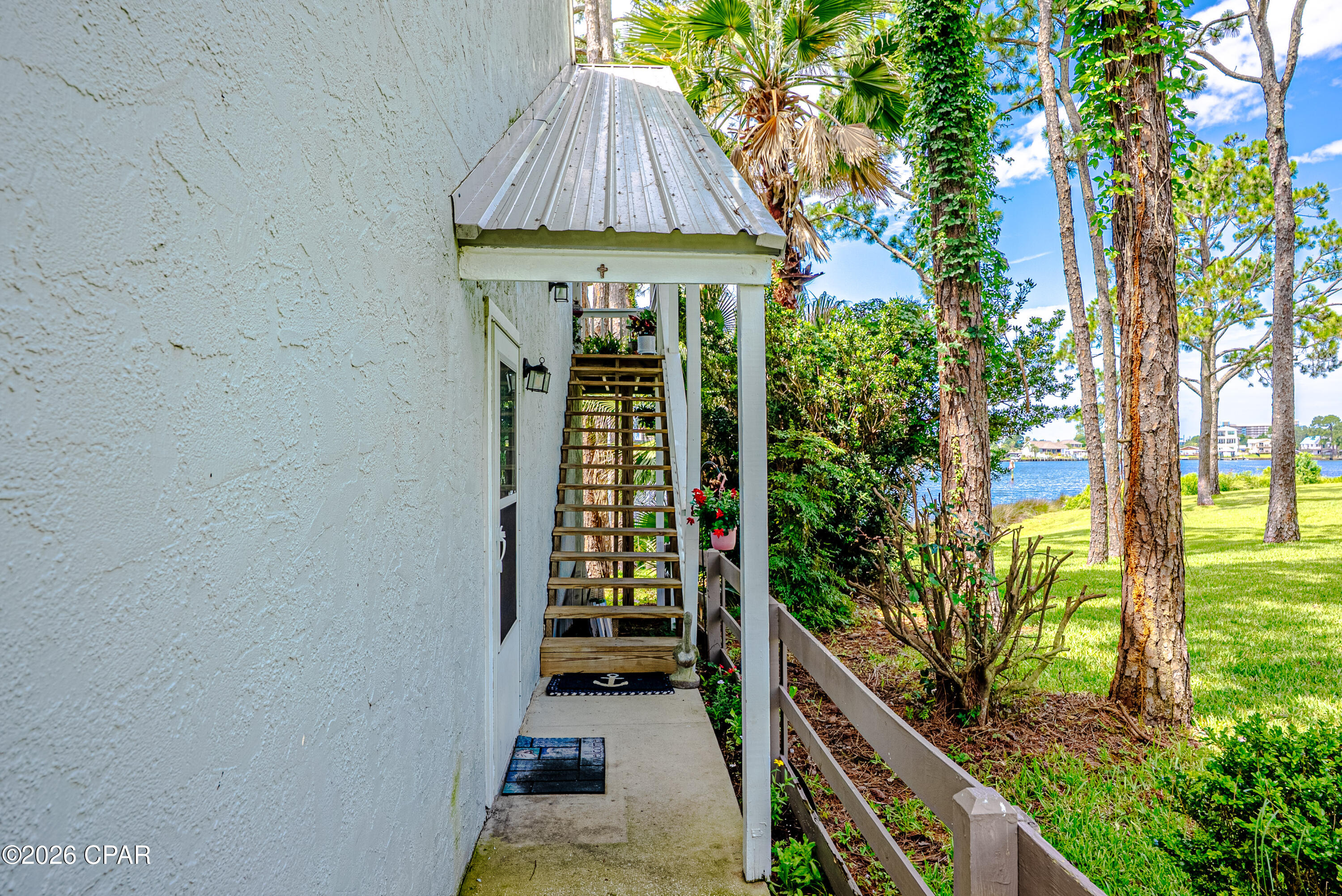 Welcome to Dockside North, a charming gated waterfront community tucked away on Grand Lagoon. This loft-style, two-bedroom, two-bath condo offers a fantastic floor plan with an open living space designed to make the most of the beautiful water views. Enjoy peaceful scenery from the living room, kitchen, and spacious deck, making it the perfect place to relax after a day on the water. With low HOA fees, this community offers an affordable way to enjoy the waterfront lifestyle.

Located in an end building, this condo overlooks the community dock, reserved exclusively for residents. Owners can keep a boat or other watercraft at the dock for up to two weeks at a time, with convenient Gulf access from Grand Lagoon. Spend your days boating, fishing, or exploring the nearby waters, then cool off in the community pool or enjoy a picnic in the beautifully landscaped green space. The location is hard to beat. You're just minutes from the white sand beaches and the natural beauty of St. Andrews State Park, one of the area's most popular destinations for hiking, kayaking, fishing, snorkeling, and wildlife viewing. When it's time to grab a bite, local favorites like Dat Cajun Place, The Big Easy, Christo's Sports Bar & Grill, and Hershey's Ice Cream are all just around the corner. You'll also be close to marinas, shopping, entertainment, and everything that makes Panama City Beach such a special place to call home.

End each day watching the sunset from your oversized deck while taking in the peaceful waterfront views. This is coastal living at its best.