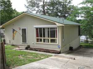 WOW !! A very well constructed and well maintained WATERFRONT HOME on COMPASS LAKE, for an incredibly LOW PRICE ! Seller has been transferred too far away to use, so said ''SELL IT QUICK''. This 2 Bedroom 2 Bath home is on Paved Road with a Dock, Boathouse, and Electric Boat Lift fronting on Jack Pond, which gives direct access to the main portion of Compass Lake. Compass Lake is an approximately 600 acre lake that allows gas motors, and is the Premier Lake in North Florida for Recreational use because of its Clean Clear Freshwater for Swimming, Skiing, Fishing, etc. Conveniently located just 35 minutes North of Panama City and 15 minutes South of Interstate 10. Very Comfortable home with good sized rooms, Fireplace in Family Room, and a Peaceful Relaxing Screened Balcony running all