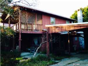 CHARMING AND AFFORDABLE 3BR FLORIDA BEACH COTTAGE on a quiet, corner lot less than 2 blocks from the water!!! This amazing home was handcrafted and is full of special unexpected touches lovingly incorporated throughout the home. It is being sold mostly furnished, comfortably sleeps 8, and is a short walk to the beach, but also has access to Lake Powell on the North side of Back Beach Rd. Per owner, new roof and new well installed last year. Vacant lot next door is included with this purchase so the possibilities are endless. Both properties are in Flood Zone X so NO FLOOD INSURANCE IS REQUIRED!!! CALL YOUR REALTOR TODAY to schedule a private showing of this one-of-a-kind gem! All room sizes are approximate--please verify if important.