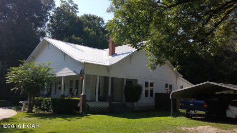 PRICE REDUCTION for this beautiful and charming home sits on .46 acres within Graceville City Limits. The circular drive leads you to the front entrance of the porch, which is such an integral part of Southern culture and you will find this porch inviting and inspiring as you enter the main part of this home with its 10 foot ceilings. The home was originally built in 1916. It has five bedroom and two full baths and one of the baths has the original claw foot tub which is absolutely beautiful. This home has many desirable updates that include a new metal roof and new double insulated vinyl windows throughout. The home is centrally heated and cooled. The 5th bedroom does have a window AC unit. There are also four propane gas heaters for even more energy efficiency. The kitchen with its many cabinets has newer kitchen appliances, but the original porcelain sink does remain. The home has updated lighting and ceiling fans. The formal dining room has beautifully refinished pine floors, while kitchen and bathrooms have new vinyl flooring. It is noted that the original pine flooring is throughout the home but the pine is covered up with carpet. The back porch is screened-in and leads to a covered patio in the back yard which has a privacy fence, a double drive gate, large shed and a tool bin. There is a detached double carport. There is a Home Warranty that Sellers are gifting.