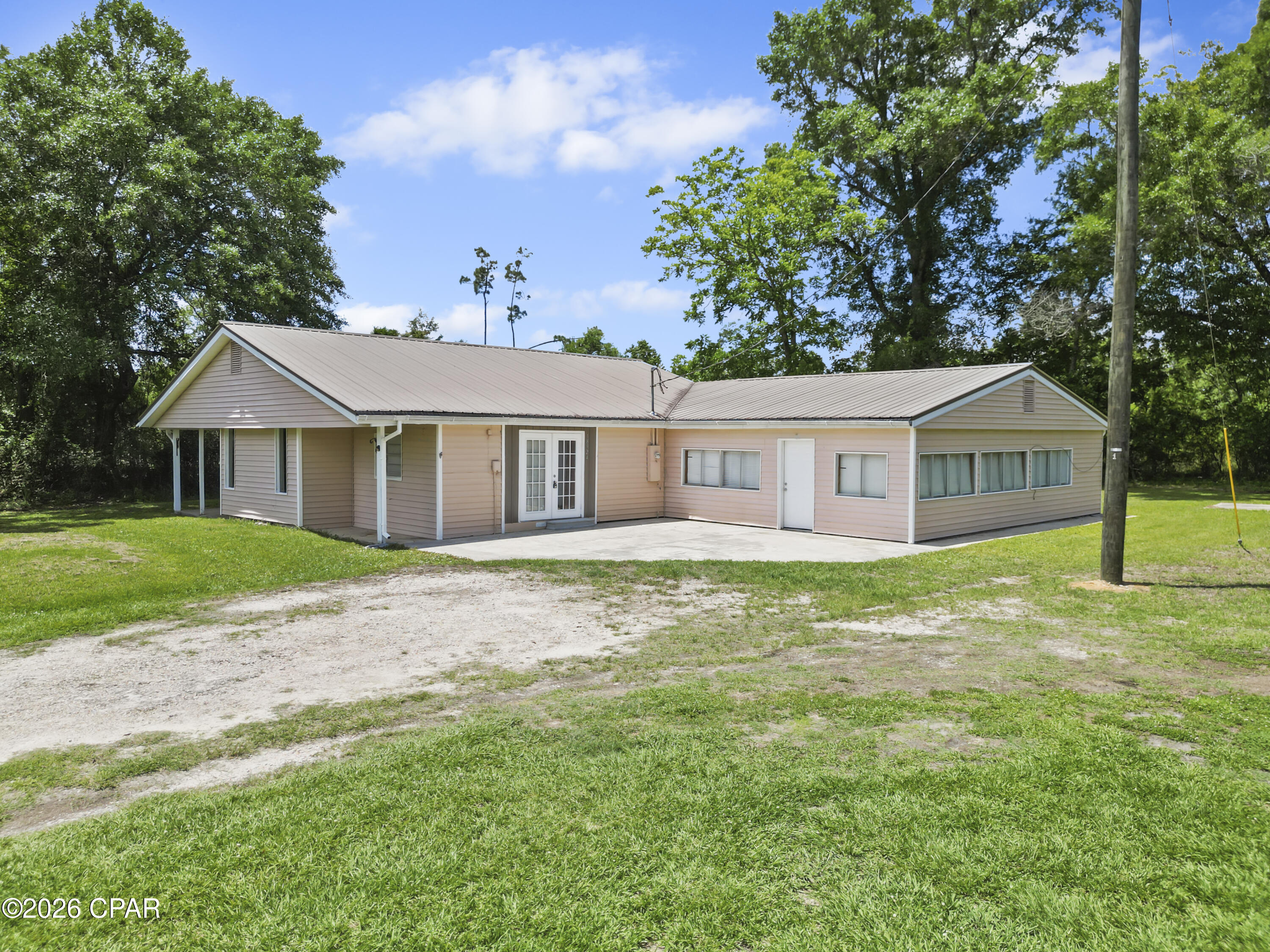 2.39 acres • 4 bedrooms • 2 baths • New AC 2025 • Metal roof • No HOA

Set on 2.39 acres in Calhoun County with a Blountstown postal address, 18924 NE Jim Durham Road offers a rare blend of space, privacy, and practical comfort. This 4-bedroom, 2-bath single-family home features 2,125 heated square feet and 2,943 total square feet, creating a spacious single-level layout designed for ease, flexibility, and everyday function.

The home's 1-story design provides a natural flow through the main living areas, bedrooms, and utility spaces. Built in 1960, the property carries a classic structure enhanced by key functional features, including ceramic tile flooring, drywall interior walls, central air, ducted heat, siding exterior, and a durable metal panel roof. Each element supports a clean, low-maintenance living experience while leaving room for personal style and future updates.

A standout improvement is the new AC system installed in 2025, offering a meaningful update for comfort and efficiency. This recent addition is a valuable feature in a home of this size, helping support dependable indoor climate control throughout the year.

The acreage is where this property truly stands apart. With 2.39 acres, the setting feels open and expansive, giving the home a sense of breathing room that is difficult to duplicate in more compact neighborhood layouts. The land offers flexibility for outdoor living, storage, parking, gardening, equipment, or other uses permitted by local regulations. The property's location just outside the center of Blountstown gives it a more relaxed feel while keeping regional conveniences accessible.

Another premium benefit is no HOA, allowing for fewer use restrictions and no monthly HOA fee. This adds to the property's overall sense of freedom and flexibility.

For those seeking a spacious 4-bedroom home with acreage, a metal roof, a 2025 AC update, and a no-HOA setting, 18924 NE Jim Durham Road is a standout opportunity. Schedule your private showing to experience the space, setting, and possibilities firsthand.