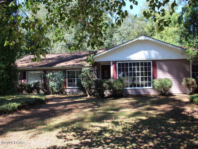 PRICE REDUCED!! What a great investment property! This home sits on a large shaded lot in town conveninelty located to all local amenities. There is a fireplace in the great room that opens up onto a deck that overlooks the back yard. It has a large eat-in kitchen, 3 bedrooms and 2 baths. Bring your tools and bring it back to it's potential! There is a yard building included.