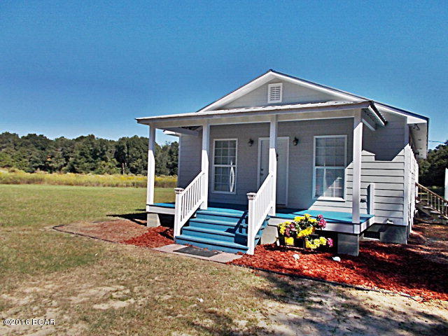 Well built and maintained country cottage on 12+ ac. this home has an open living room, dining room, kitchen which makes it seem larger than it is, it also features a nice master bedroom with master bath and closet. Metal roof, plus over 12 ac of land, great hunting, deer, turkey, lots of cleared land for garden or pasture, and all of this is just minutes from the public boat landing of Ocheesee pond,a 2,225 acre lake with plenty of bream, shellcracker, large mouth bass. Call agent to view this home and start living the country life again.
