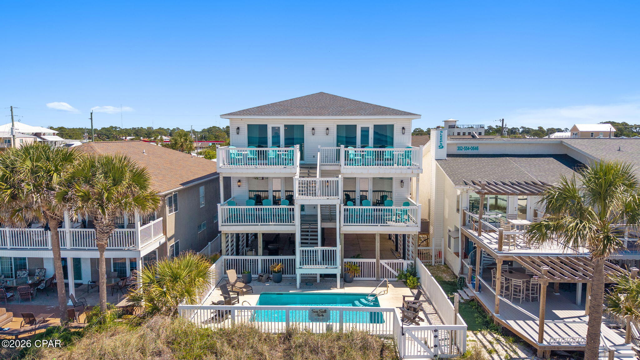 An exceptional Gulf-front investment opportunity where luxury meets income potential. With more than $330,000 in proven rental income in 2025. This stunning coastal property features four beautifully appointed two-bedroom units, offering a total of 8 bedrooms and 8 full bathrooms, all thoughtfully designed to maximize comfort, style, and revenue.

Perfectly positioned directly on the Gulf, the property showcases breathtaking Panama City Beach sunsets and uninterrupted water views from private balconies for every unit, creating an unforgettable experience for guests and owners alike. A Gulf-front pool provides the ultimate setting for relaxation, while the pristine white sand beach is just steps away.

Inside, each residence is finished with upscale coastal touches, including gorgeous white oak luxury vinyl plank flooring, open-concept kitchens, and striking shiplap ceilings that enhance the bright, airy atmosphere throughout. The layout of each unit is designed for both functionality and entertaining, making it ideal for short-term rentals or multi-family use.

On the ground level, covered parking beneath the home offers both convenience and additional entertainment space, complete with grilling areas, tables, games, and gathering spots--perfect for hosting guests and creating memorable beachside experiences.

With rental projections reaching as high as $385,000 per year, this property presents a rare opportunity to own a premier Gulf-front income-producing asset in one of Panama City Beach's most desirable locations.

Whether you're expanding your portfolio or seeking a luxury coastal retreat with exceptional returns, this one-of-a-kind property delivers the perfect blend of location, lifestyle, and long-term value.