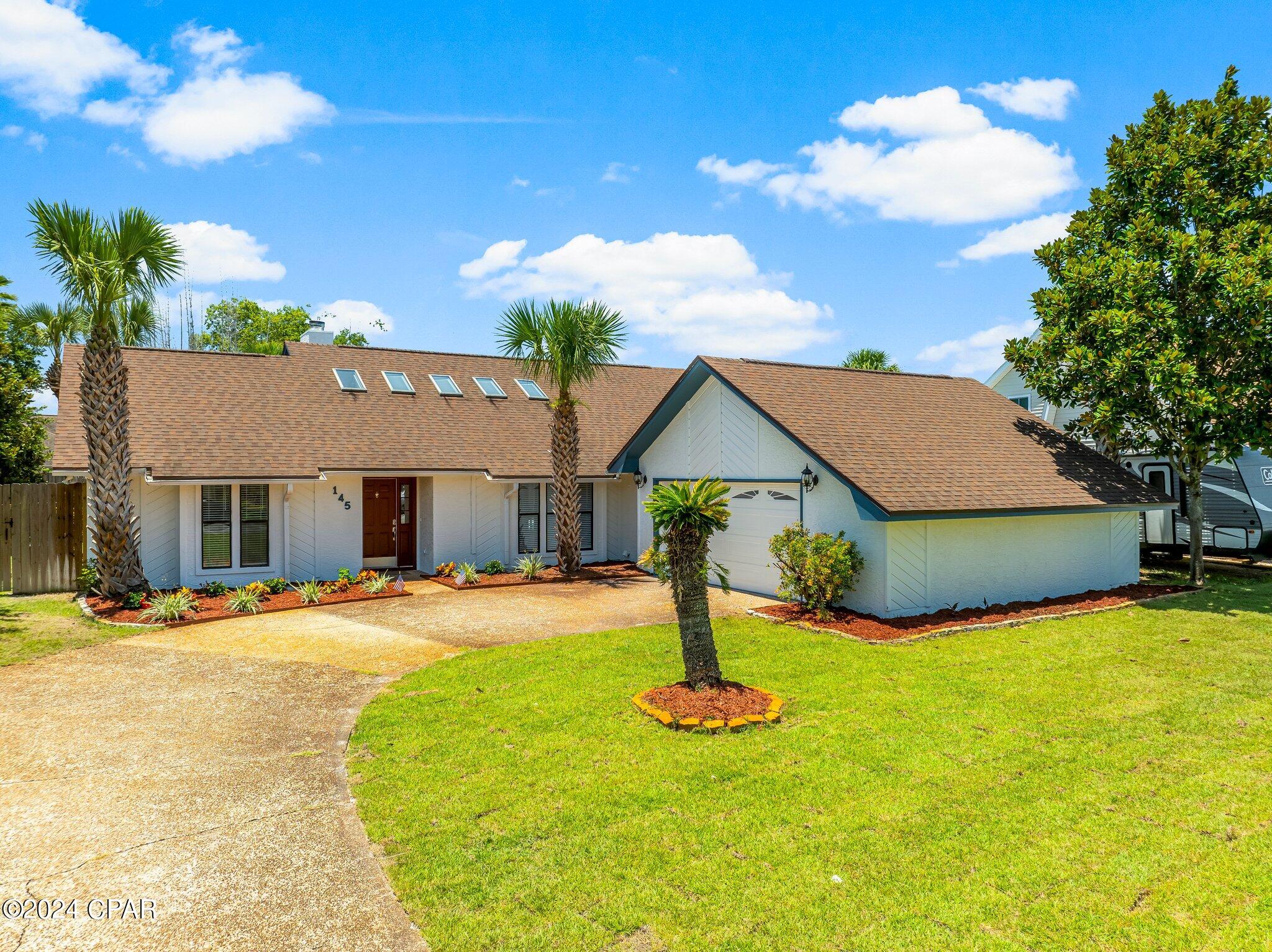 Welcome to 145 Grand Lagoon Shores, a stunning home in a prime location near North Lagoon on Panama City Beach. This residence features three bedrooms, two full bathrooms, a half bath for guests, and an inviting in-ground pool. The property boasts a spacious driveway leading to a two-car garage, complete with extra storage space. Inside, you will find a sizable family room that seamlessly connects to the dining area and kitchen. Sliding doors open to a fenced backyard, providing easy access to the pool.
The well-designed floor plan includes a split layout with two bedrooms and a bathroom on the left side of the house, while the large master bedroom with a full en-suite bathroom is situated on the opposite side for added privacy. Recent updates include a fully renovated bathroom, new luxury vinyl plank (LVP) floors in bedrooms, and fresh paint both inside and out. In 2022, the pool was resurfaced and pavers were added around it, enhancing the outdoor living space.
Additional features of this home include a sprinkler system connected to a well, ensuring you won't have to worry about high water bills. Grand Lagoon Shores offers a convenient location near the Navy Base, grocery stores, restaurants, and the beautiful Gulf of Mexico. This home is ready for you to move in and enjoy the best of Panama City Beach living.