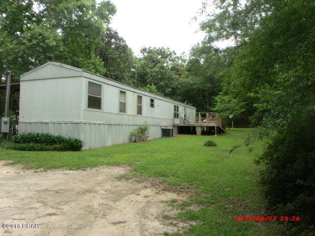 **PRICE REDUCTION** WELL MAINTAINED MOBILE HOME JUST OUTSIDE CITY LIMITS OF MARIANNA ON PAVED ROAD. This is a move in ready, 2 bedroom 2 bath mobile home on 8.98 acres in a very quiet, peaceful setting. Home features split floor plan, front deck and very large back porch. There is a large pole barn in the back yard. Heat Pump approximately 5 years old. Property is mostly fenced on three sides. Gate in back yard leads to additional acreage. This is a beautiful setting with plenty of wildlife to enjoy. Make an appointment today!