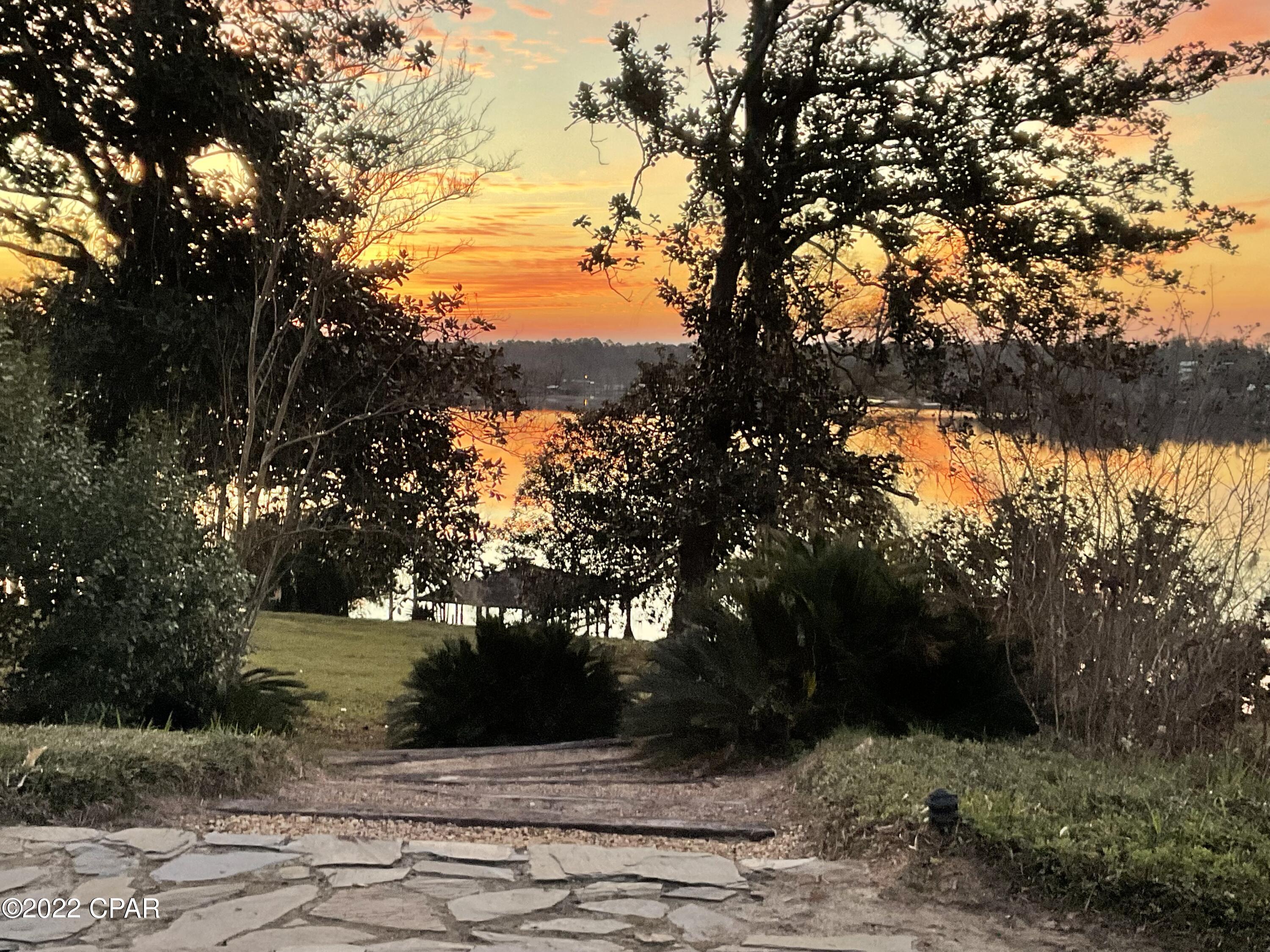 Welcome to one of the most beautiful lakefront properties in North Florida. Resting on crystal clear Compass Lake, this one-of-a-kind 5+ acre property offers you the best of all worlds- the peaceful privacy of an inviting all-natural landscape, swimming, boating and fishing in one of Florida's cleanest spring-fed sandy bottom lakes.  The property has  extensive private beachfront (over 500 feet) existing docks, a boathouse, a 2-car garage, a 1 Bedroom, 1 bath apartment as well as carport.  The property could be subdivided or be a beautiful large building lot for new construction.