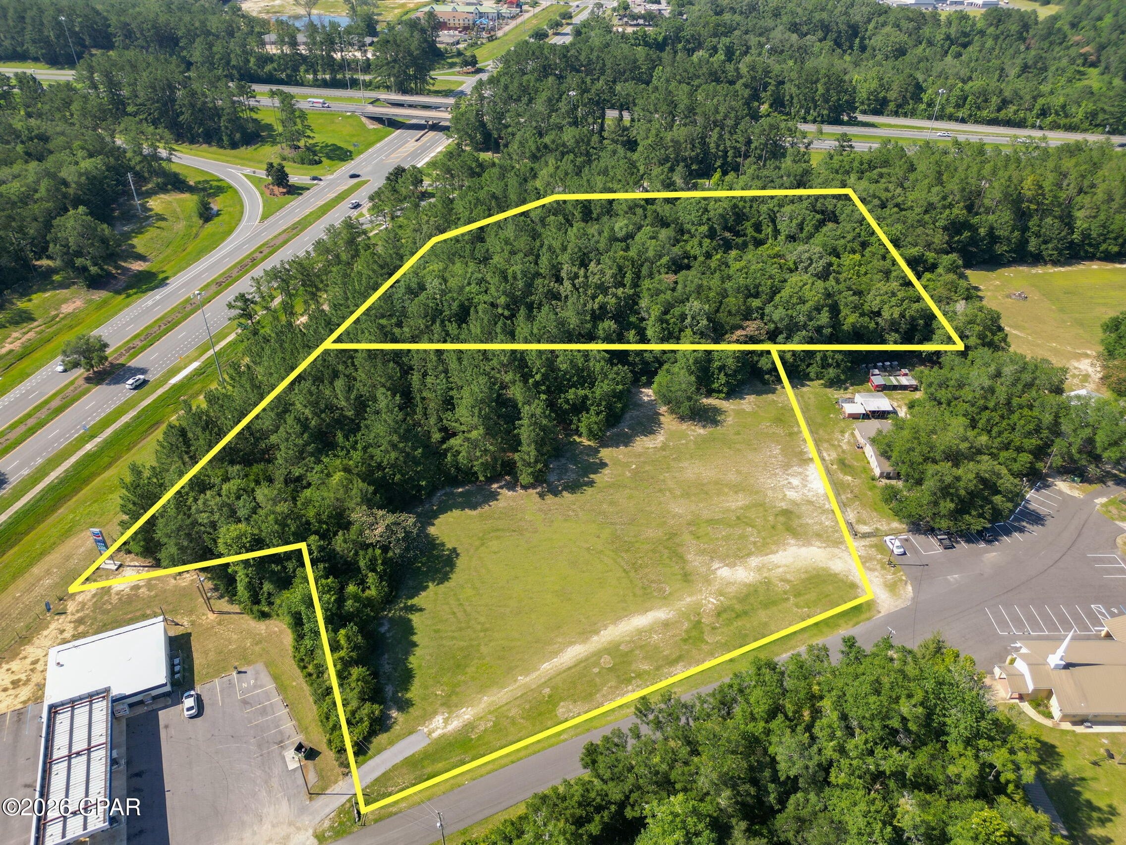 Positioned in one of Washington County's most visible and strategic commercial corridors, this 6.92+/- acre property offers exceptional exposure at the intersection of Highway 77 and I-10. With frontage along Blue Lake Road, Highway 77, and the entrance ramp to eastbound I-10, this property provides outstanding visibility for a wide range of commercial opportunities. Access will be from Blue Lake Road off Highway 77, offering convenient entry while maintaining prime highway presence. City of Chipley municipal water and sewer are now available, and natural gas casings under I-10 have been completed to service this growing area of commercial properties. With a DOT traffic count of approximately 8,900 vehicles per day on Highway 77, this site is well-positioned for development in a high-traffic location with strong future potential.