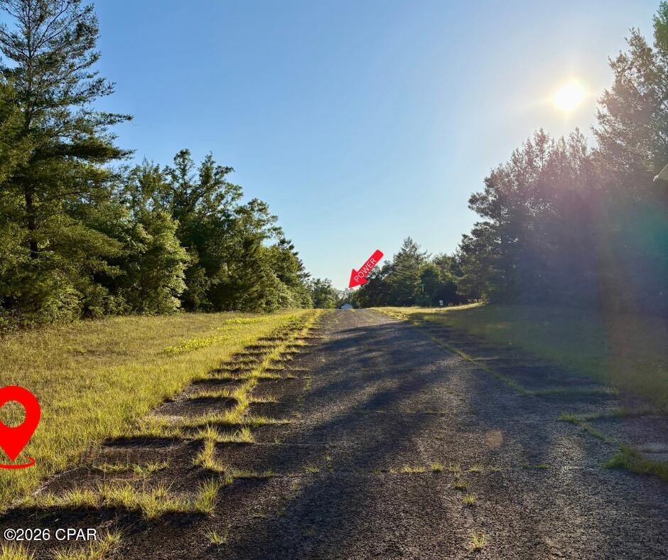 Flat, lightly wooded lot located just off of Country Club, approximately 1,000 feet from power. Quick drive to the golf course and Gap Lake! For nature lovers and outdoor enthusiasts, Gap Lake has great fishing and is not too far away either, it is an 800+ acre freshwater paradise. Enjoy serene views of majestic cypress trees and experience excellent fishing opportunities right in your neighborhood. Additionally, a county boat ramp on Gap Lake makes for easy access to all your water adventures. Sunny Hills is a growing golf course community with a lot of new construction happening. It's ideally situated just under 30 minutes from both Chipley, Lynn Haven, and the airport- offering the best of both worlds: a slower, laid-back lifestyle while still being close to city amenities. Plus, you're less than an hour away from the white sands of Panama City Beach! Sunny Hills also offers many freshwater lakes for fishing and boating and also a swim park at spring-fed Boat Lake for seasonal fun. This deed-restricted lot is reserved for building only, ensuring a well-maintained community without the burden of HOA fees. Enjoy the tranquility and convenience of life in Sunny Hills! Buyer to do their own due diligence about getting utilities on the property. Buyer to pay for owner's title policy/title fees.