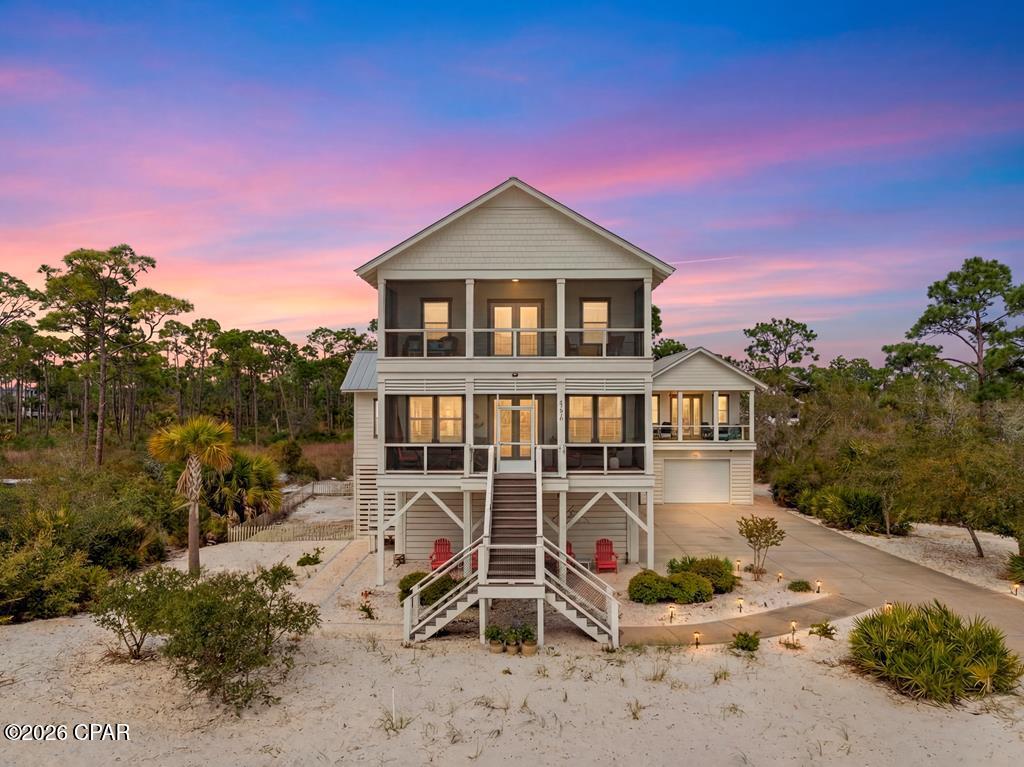 Welcome to 434 WindMark Way, a 4BR/4.5BA home with FOUR GARAGES located in the gated WindMark Beach Phase 1 community, offering 3,438 square feet of living space on a .44-acre lot with great Gulf views AND a completely detached guest house with its own garage. Built in 2015 and recently updated, this home is move-in ready and designed for both full-time living and second-home use. The main living area features an open-concept layout with raised ceilings, a fireplace, and an oversized kitchen with a large island, breakfast bar, large pantry, and plenty of cabinet spaceand a downstairs bedroom with its own private bathroom. An elevator services all floors, making access easy throughout the home. Upstairs, the primary suite is a true standout, offering an office area, sitting room with a mini fridge and bar sink, private balcony with beautiful water views, and a spacious bathroom featuring two walk-in closets, double vanities, a two-head walk-in shower, and a private water closet. In addition to the main home, there is a detached guest house above one of the four garages, creating an ideal setup for guests, extended family, or additional rental flexibility. The property offers ample parking and storage, along with natural gas and functional outdoor space. Located just a short walk from the community pool, boardwalk, and beach access, as well as the neighborhood dock, this home combines convenience with one of the best locations in WindMark. With short-term rentals allowed, strong Gulf views, and a flexible layout, 434 WindMark Way is a solid opportunity in one of the most desirable communities in Gulf County. Call today!