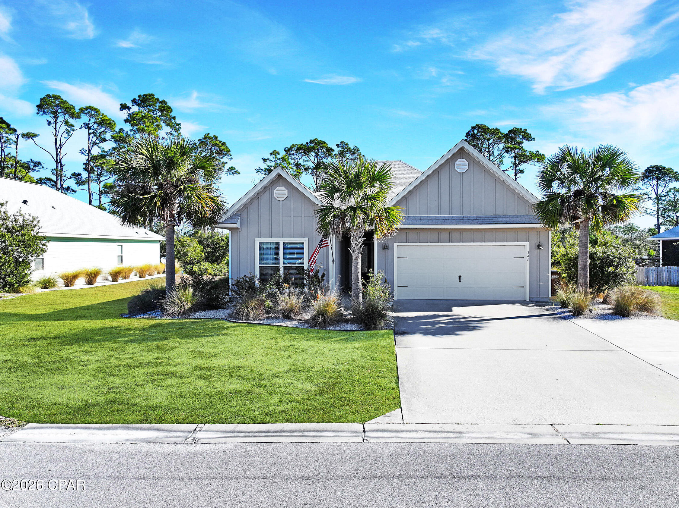 WindMark Beach Kennedy model with an attached in-law suite which includes a full kitchen, living area, bedroom, and separate entrance - ideal for extended family, added privacy, or short-term rental potential. This thoughtfully designed 2,144 sq ft home offers an open-concept floor plan with split bedrooms for comfort and functionality. The bright white kitchen features stone  countertops, stainless steel appliances, an island with seating and a pantry which all flow seamlessly into the living and dining areas and the screened porch--perfect for entertaining.The main home includes three bedrooms, including a bunk room. The private primary suite is tucked away at the rear of the home, overlooking the yard and natural area. A full-length back deck steps down to the yard, where a hidden path leads through the natural area to the creek--perfect for setting crab traps or catching fresh bait for your next fishing trip. WindMark Beach is a vibrant coastal community with miles of trails, paths, and boardwalks to explore by foot, bike, or golf cart. Enjoy white-sand beaches and abundant wildlife, including fish, dolphins, and birds. Kayaking and boating are popular, with easy access to multiple bays and the Gulf. Visit Good Morning Street for the pool, food, drinks, cornhole or relaxing by the community fire pit. Ideal as a full-time residence, vacation home, or investment property with short-term rentals allowed. Come take a look today.
