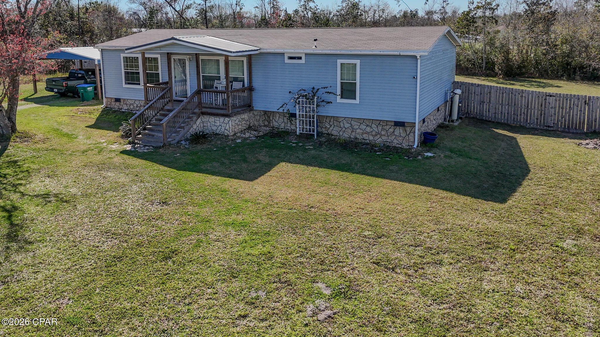 CURRENTLY UNDER CONTRACT, SELLER WILL CONSIDER BACKUP OFFERS Discover the perfect blend of comfort, style, and space in this beautifully maintained 2020 home on nearly an acre just off John Pitts Road. From the moment you arrive, the oversized carport and inviting covered front porch welcome you home to a generous front yard, ideal for relaxing or entertaining. Step inside to a light-filled, open-concept layout designed for modern living. The expansive living and dining areas flow into the kitchen, featuring a large island, breakfast bar, upgraded sink, stainless steel appliances, and a walk-in pantry, making this the heart of the home. Retreat to a spacious primary suite with a luxurious walk-in shower and premium luxury vinyl plank flooring. Two additional bedrooms and a large laundry room with extra freezer space provide all the functionality a growing family needs. This home is move-in ready. Enjoy outdoor living with both front and back covered porches, a fully fenced backyard with double gate access, and scenic natural views. Extras include vinyl siding, recessed lighting, crown molding, a large 12x32 storage shed with a workshop on a slab, an attached carport, and well and septic utilities. Don't miss this rare opportunity--schedule your private tour today. This property is perfect for those who want to live and work in Bay County while enjoying the privacy and space of a large yard.