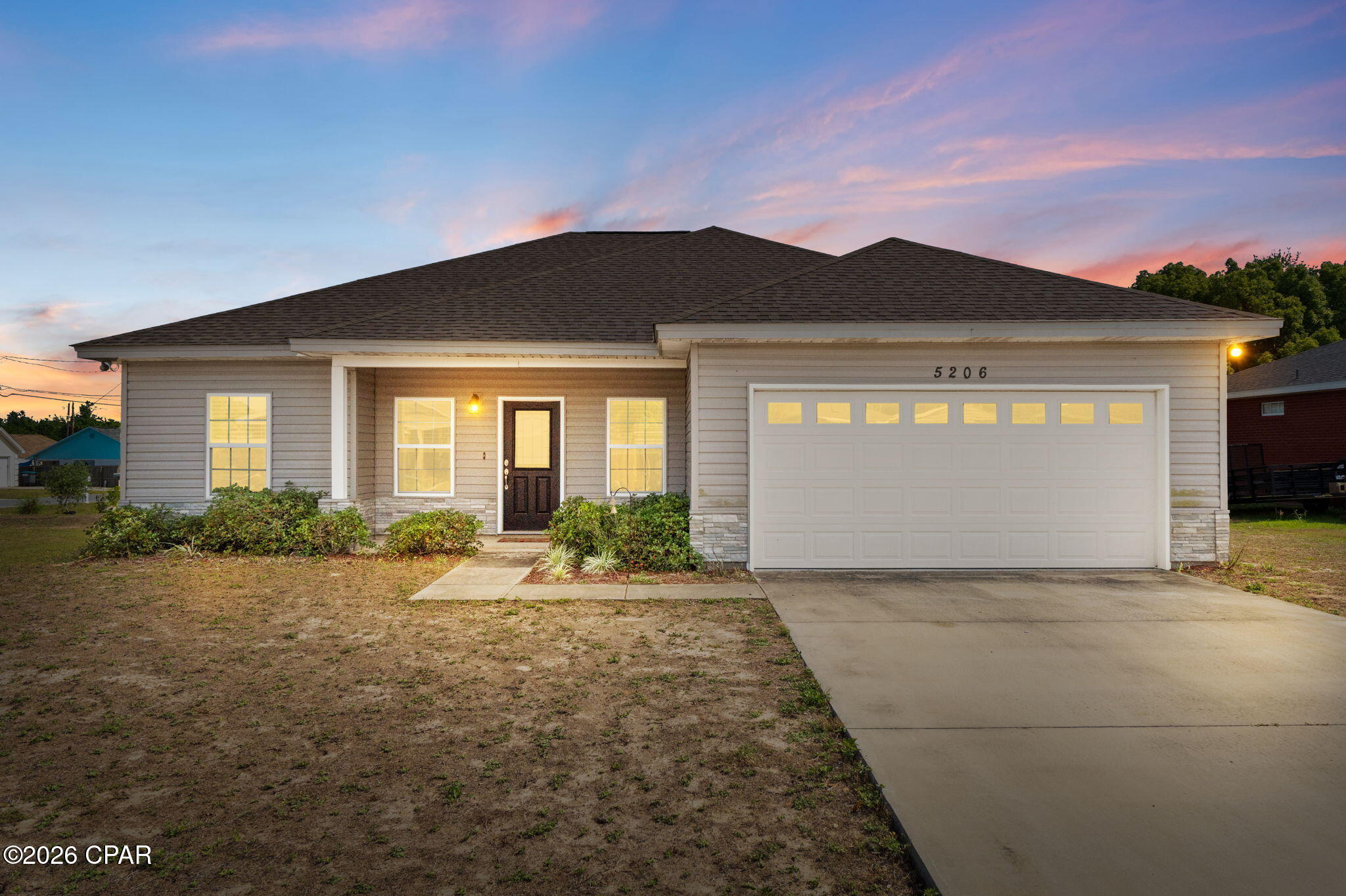 Built in 2020, this stunning home combines modern style with a warm, inviting presence. On a corner lot in a nice and quiet cul-de-sac. Enter into and open concept floorplan featuring raised ceilings, wood-look tile plank flooring and recessed lighting. Main space is bright and airy with plenty of natural light. This kitchen boasts beautiful custom cabinetry, stainless steel appliances and a spacious island with breakfast bar. Dining space right next to kitchen. Sizable master suite with 9ft ceilings. En-suite offers a double vanity and an oversized walk-in closet. Split floor plan gives additional privacy to master suite. Both guest rooms are generously sized and feature spacious closets. Privacy fenced backyard with covered patio, a great space to relax with a cup of coffee in the morning or to entertain family and friends. The 2-car garage features a lifetime epoxy flooring and fold out workbench. Irrigation system to help keep the grass green for improved curb appeal. Fantastic proximity to Tyndall Air Force Base, just 3.7 miles away. Also just a short drive to Mexico Beach and 10 minutes to Downtown Panama City! The home is move-in ready and pride of ownership is on display from the moment you arrive. Schedule your visit today!