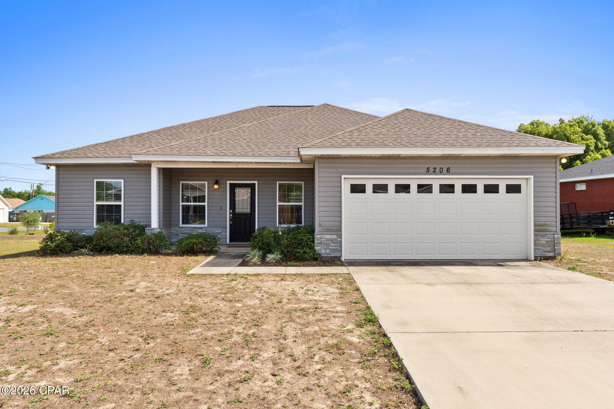 **OPEN HOUSE 5-31-26 FROM 1-3 PM**

Built in 2020, this stunning home combines modern style with a warm, inviting presence. On a corner lot in a nice and quiet cul-de-sac. Enter into and open concept floorplan featuring raised ceilings, wood-look tile plank flooring and recessed lighting. Main space is bright and airy with plenty of natural light. This kitchen boasts beautiful custom cabinetry, stainless steel appliances and a spacious island with breakfast bar. Dining space right next to kitchen. Sizable master suite with 9ft ceilings. En-suite offers a double vanity and an oversized walk-in closet. Split floor plan gives additional privacy to master suite. Both guest rooms are generously sized and feature spacious closets. Privacy fenced backyard with covered patio, a great space to relax with a cup of coffee in the morning or to entertain family and friends. The 2-car garage features a lifetime epoxy flooring and fold out workbench. Irrigation system to help keep the grass green for improved curb appeal. Fantastic proximity to Tyndall Air Force Base, just 3.7 miles away. Also just a short drive to Mexico Beach and 10 minutes to Downtown Panama City! The home is move-in ready and pride of ownership is on display from the moment you arrive. Schedule your visit today!