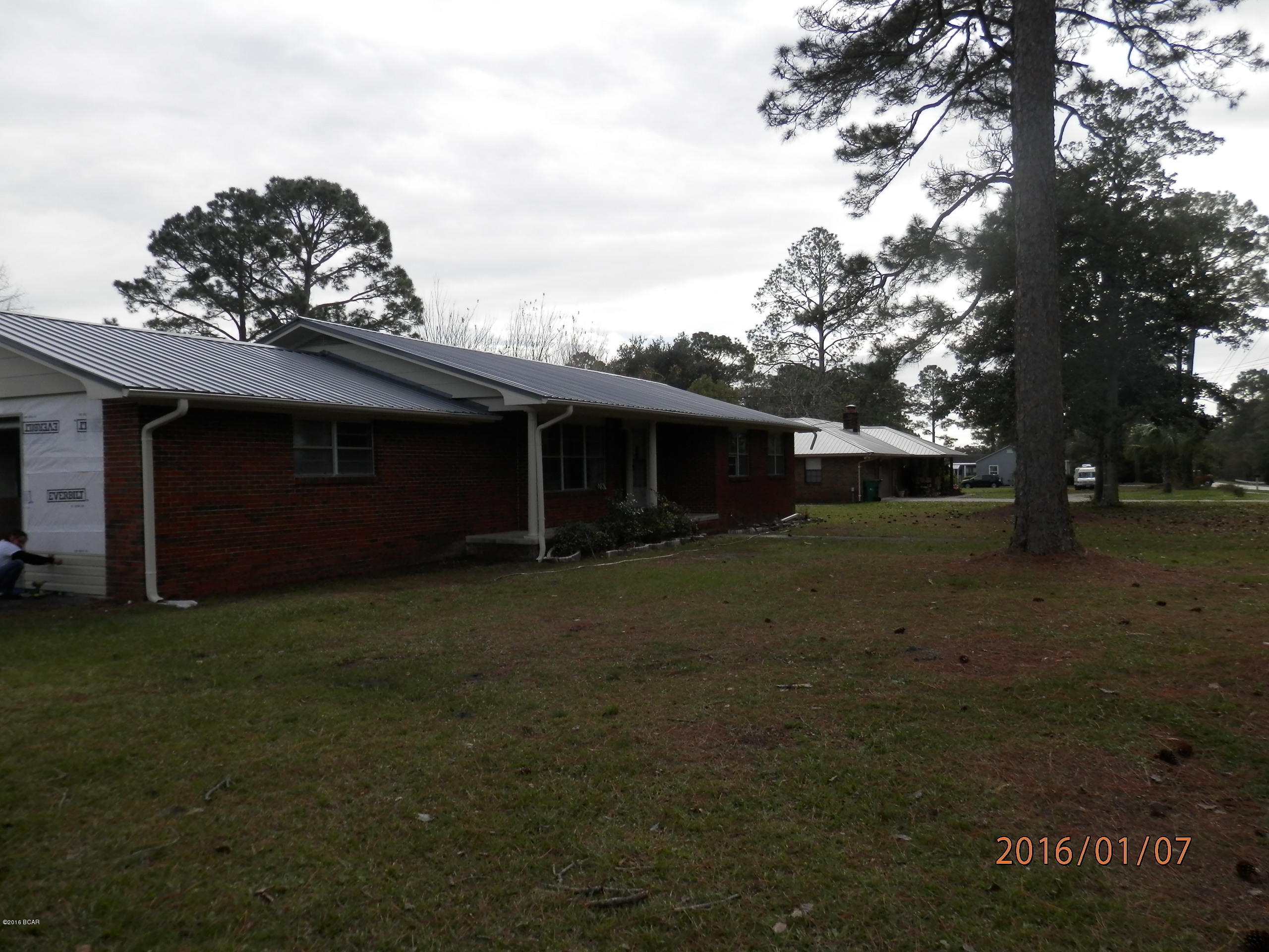 Newly remodeled brick home with fresh interior and exterior paint, single car over sized garage with lots of storage space. Located on a nice size corner lot, almost 1/2 acre. Block detached building in back. There is new flooring throughout the home with carpet in the bedrooms and living room, laminate wood floors in the kitchen, dining room and halls as well as the mud room leading out to the garage from the kitchen area. Large tiles laundry room just past the kitchen. Kitchen cabinets are refinished and new counter tops as well as tile back splash. Bathrooms are tiled. The home has a new metal roof as well as the 20x23 detached block building. just off the dining room is a large covered porch great for BBQ'S.