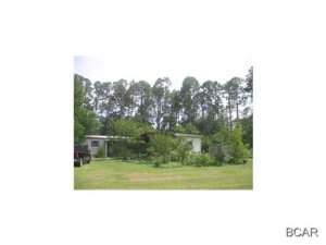 Income and investment property! This property has heavy commercial zoning which will cover almost any business you would like to operate. Great opportunity since this parcel fronts busy four lane Hwy 77. Get your offer in fast, this area is a hotspot with developers. Zoned C-3 Heavy commercial. Mobile home has no value but is presently providing rental income and could possibly serve as an office, and what a plus to have electric, water, and septic already to the lot. Property has 131 commercial footage on busy Highway 77 by 187 deep and access crossing to four lane highway. No impact fees! This area is growing and within twenty minutes of the PCB International Airport. Take advantage of this while the prices are at an all time low! Please do not approach occupant of mobile home. Call  for viewing of property. Check with Bay County water, public water is available. Great location across from Panhandle Credit Union.