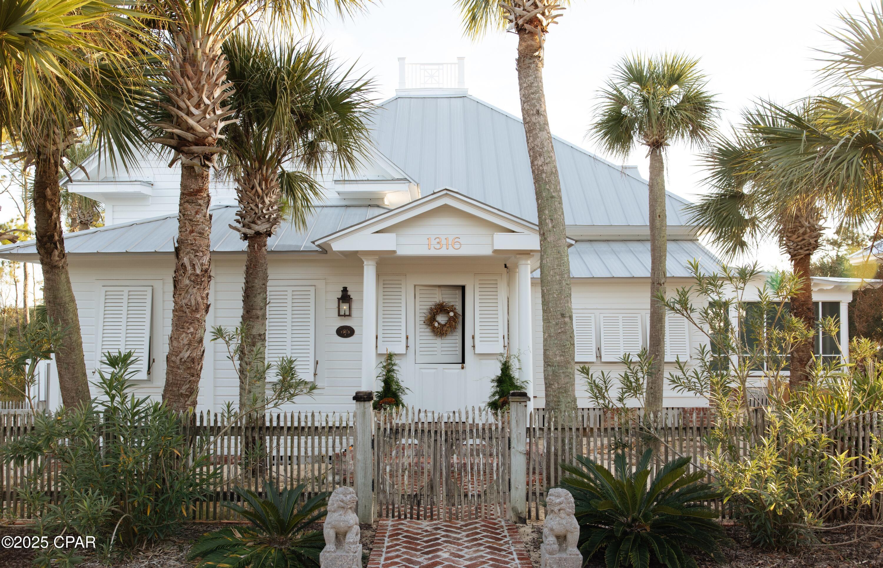 Welcome to an architectural gem gracefully poised on the sugar-white sands of Florida's pristine Gulf Coast. Known to many as The Jewel of Indian Pass, this distinguished residence, originally constructed in 1903, has been meticulously relocated and masterfully restored to its original grandeur. Nestled on over an acre of Gulf-front property with 95 feet of private beachfront, this estate effortlessly blends historic Old Florida charm with understated modern luxury.

Every detail of this three-bedroom, four-and-a-half-bath home has been curated with exceptional craftsmanship and reverence for its historic origins. From the soaring 12'6'' heart pine ceilings to the rich original heart pine custom trim, walls, and floors, including 8 fireplaces.