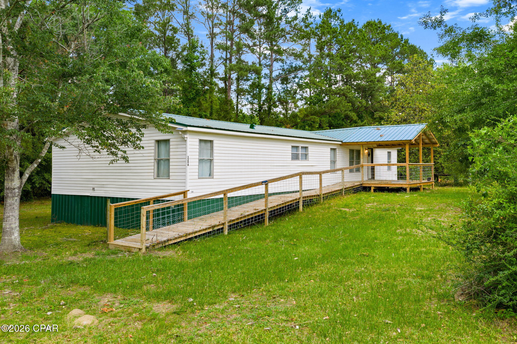 Tucked away in the peaceful town of Vernon, this spacious 4-bedroom, 2-bath home offers over 2,000 square feet of comfortable living space in a beautiful rural setting just minutes from some of Northwest Florida's most sought-after natural springs.

Inside, the home features a large open living area, a generous kitchen with ample cabinetry and space for an island, and a flexible split-bedroom layout designed for everyday comfort. The oversized primary suite includes a beautifully tiled walk-in shower along with an attached bonus space that would make an ideal home office, library, hobby room, dressing area, fitness space, or future custom closet expansion.

Recent updates throughout the home, including a newer metal roof, provide a clean, move-in-ready feel with modern touches and spacious rooms throughout. Covered porches on both the front and back of the home add to the charm and create inviting spaces to relax and enjoy the surrounding natural setting. Select furnishings may be negotiable with an acceptable offer.

Located next door to Cypress Springs Canoe Adventures and approximately 5 miles from Cypress Springs itself, this property places outdoor recreation right at your doorstep. Enjoy convenient access to kayaking, canoeing, spring-fed waters, and the natural beauty that makes Washington County such a special part of the Florida Panhandle. A volunteer fire station is also located less than 2 miles away, and buyers are encouraged to verify any potential insurance credits related to proximity to fire services.

If you've been searching for space, flexibility, and a quieter pace of life without sacrificing access to outdoor adventure, this Vernon property is one worth seeing in person.