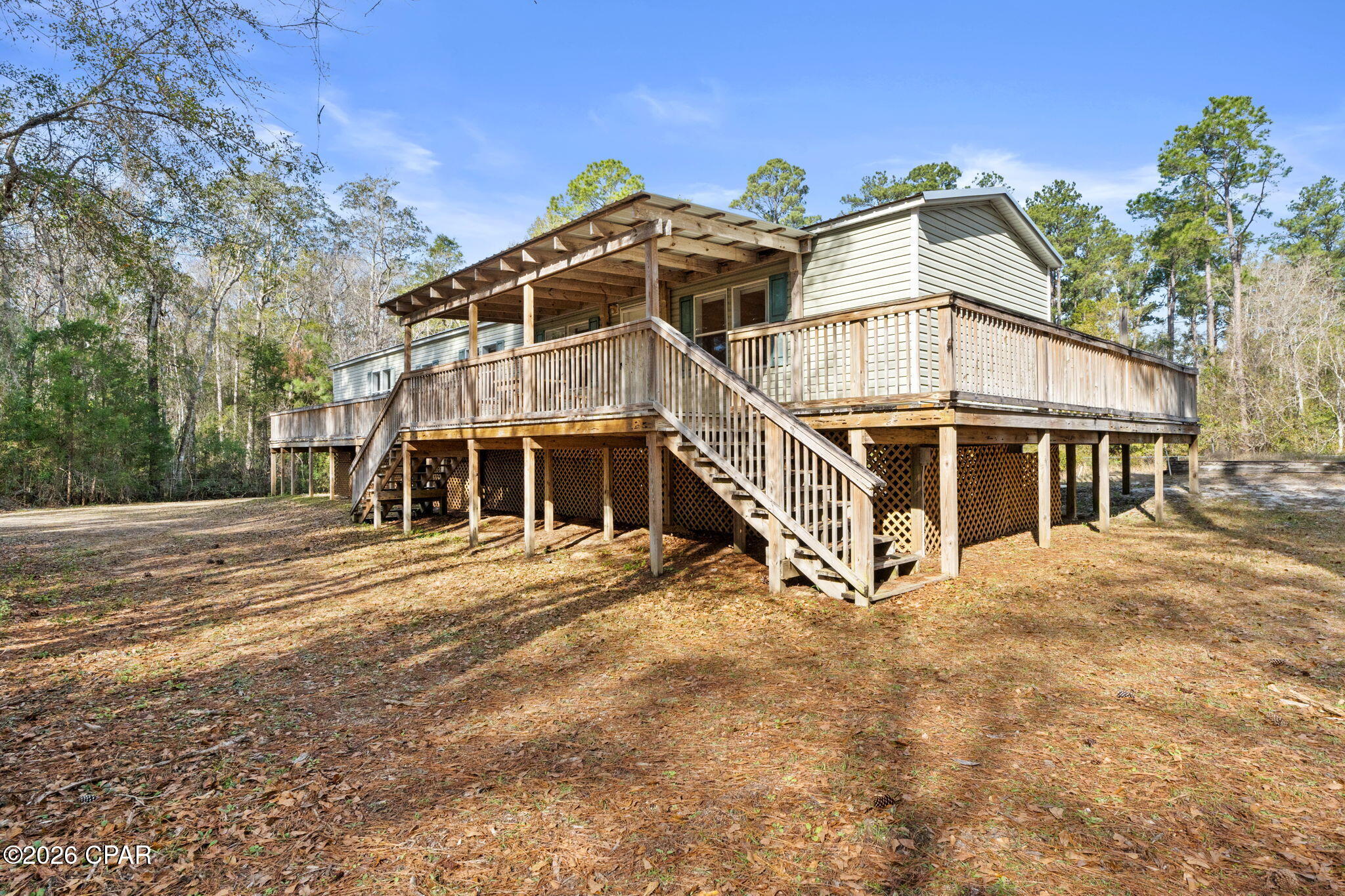 **Owner Financing may be Available to Qualified Buyers.** Welcome to 6919 Nellie Whitfield Rd at Howard Creek  - a property that delivers space, privacy, and the kind of setup serious hunters and outdoor enthusiasts appreciate. This property has serious short term rental possibilities,

This elevated home is surrounded by natural woods and wide-open land in the heart of North Florida. With multiple freshwater boat launches and a nearby wildlife management area in Howard Creek, prime access to hunting, fishing, and year-round outdoor recreation comes easy. Whether you're chasing deer and turkey, running dogs, or heading out to nearby rivers and creeks, this location puts you right where you want to be without sacrificing comfort. Spend your mornings in the woods or on the water, then head back home to reset and recharge.

The home features expansive wraparound decking, including covered sections that are perfect for early mornings, gear prep, or unwinding after a long day outdoors. The elevated design provides added durability and airflow, while the space below offers practical covered storage for equipment, coolers, and tools.

Inside, the stone fireplace anchors the main living space, creating a solid, lodge-style atmosphere. The kitchen and dining area are built for function - plenty of storage, stainless appliances, and room to fuel up before the hunt or host a post-season cookout. Natural light and multiple access points connect indoor living seamlessly to the outdoors.

The covered pole barn/workshop is a standout feature ideal for boats, ATVs, trailers, tractors, or a dedicated workshop. There's room here to store what matters and work on what you enjoy.

Located in Wewa, this property offers true rural freedom with easy access to surrounding hunting land, waterways, and back roads - while still being a manageable drive to town amenities and the Gulf Coast. Port St. Joe and Mexico Beach are just a short drive away, offering deep-water fishing, dining, and Gulf Coast adventures - giving you the best of both worlds: quiet country living with coastal access when you want it.

If you're looking for a property where the land matters, the access matters, and the lifestyle matters, this one delivers.

6919 Nellie Whitfield Rd, where your weekends start and the outdoors come standard.


Schedule your showing and see what this property has to offer!