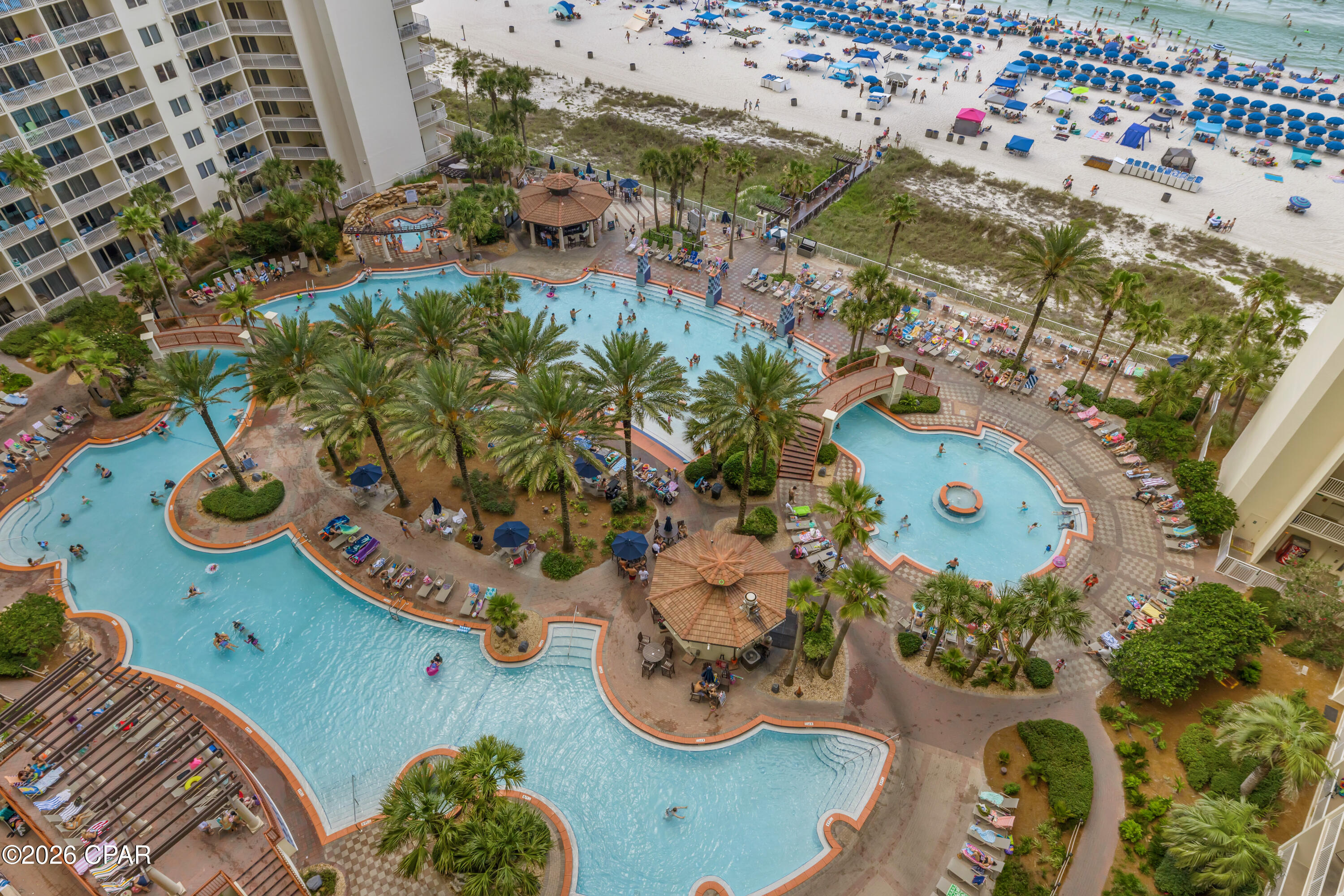 CENTERED VIEWS. DEEDED PARKING. GULF-FRONT PRIMARY SUITE. Shores of Panama Unit 1412 features the highly sought-after Type C floor plan with two bedrooms, two bathrooms, and a layout that includes a Gulf-front primary suite plus a private bunk room serving as the second bedroom.

Centrally located both vertically and within the resort's signature horseshoe design, Unit 1412 brings the pool, beach, and Gulf together in one impressive view corridor. The spacious living room opens to a large balcony where you can enjoy wide views of the Gulf of Mexico, sugar-white sand, and the resort's lagoon-style pool.

The Gulf-front primary suite offers direct water views and a private ensuite bathroom. The private bunk room is located near the adjacent full bathroom, creating a practical layout for owners and rental use. With a pull-out sofa in the living room, the condo comfortably accommodates up to six guests.

The kitchen has been updated with white shaker cabinetry, Ubatuba granite countertops, and stainless steel appliances. Additional interior details include crown molding in the living room, an open main living area, and a layout designed to keep the view front and center.

A deeded parking space on the fourth floor adds valuable convenience, especially in a resort where parking access can make a meaningful difference. 

Shores of Panama Resort is known for its expansive Gulf-front lagoon pool, one of the largest in Panama City Beach. The resort-style pool area features zero-entry access, palm-lined islands, fountains, a spacious hot tub, and direct private beachfront access. Additional amenities include an indoor heated pool and hot tub, 24-hour fitness center, and seasonal poolside Tiki bar. Located in the heart of Panama City Beach, Shores of Panama places dining, shopping, and entertainment nearby. Pineapple Willy's is adjacent to the resort, and Laketown Wharf directly across the street offers several dining, retail, and entertainment options, including Wharf Seafood Buffet, The Candymaker Ice Cream Shop, PCB Pizza, In Cahoots, The Press, The Bun Lab, 810 Billiards & Bowling, salon services, and more. Panama City Beach has also welcomed several newer attractions and entertainment venues, including Dolly Parton's Pirates Voyage Dinner & Show, Topgolf, McGuire's Irish Pub, and Tootsie's Orchid Lounge. HOA dues are $3,491.71 per quarter. All information is believed to be accurate but should be verified by buyers if important.