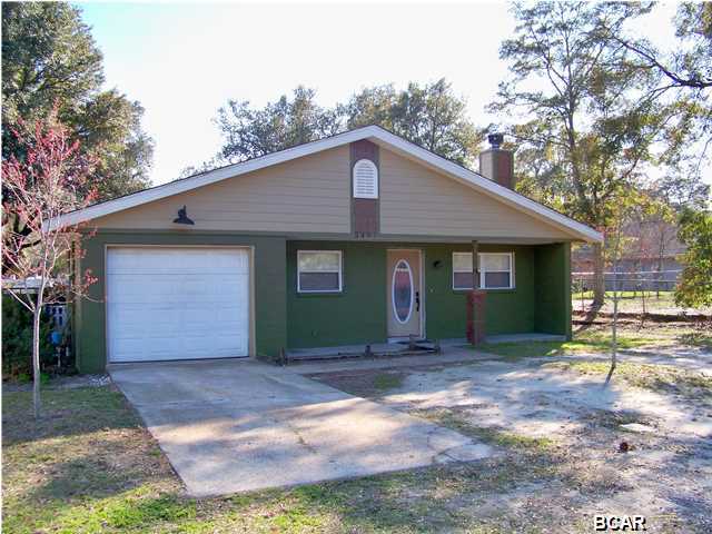Imagine owning a home within walking distance to the Bay and to the Heart of St. Andrews where you could enjoy dining, shopping, entertainment, weekly Farmers' Market and annual Mardi Gras festivities just to name a few. Well, your time has come. This adorable home is perfect for either a first time buyer or maybe a second home. Along with its white picket fence, it has been upgraded with features such as hard wood floors, bead board, chair rail moulding, two fireplaces - one in the living room and one in the master bedroom - intricate tile work in both bathrooms and the kitchen. The kitchen has tile back splash, breakfast bar, and lighted cabinets. Storage is not a problem. Not only does each bedroom have a spacious closet, there is a pantry, a one car garage with a storage room and