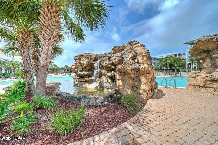 Welcome home to Island Reserve...this gated community is centrally located in the heart of Panama City Beach just a short drive to the Navy Base, beautiful gulf beaches, shopping, golf and fabulous waterfront dining as well as St. Andrews State Park!  This is the ALL ONE-LEVEL 1 bedroom plus bonus room  floorplan offering granite, stainless appliances plus washer/dryer stay! Seller added custom built-ins.  Island Reserve offers exquisite sparkling pool with waterfall, media center, indoor basketball, gym, clubhouse and hot tub!